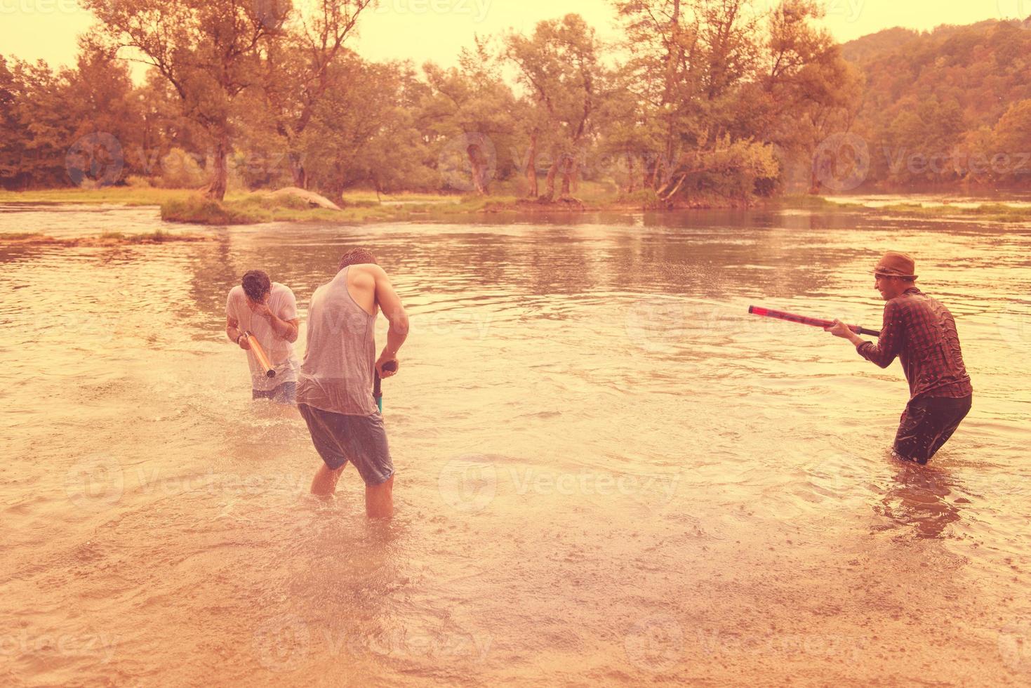 young men having fun with water guns photo