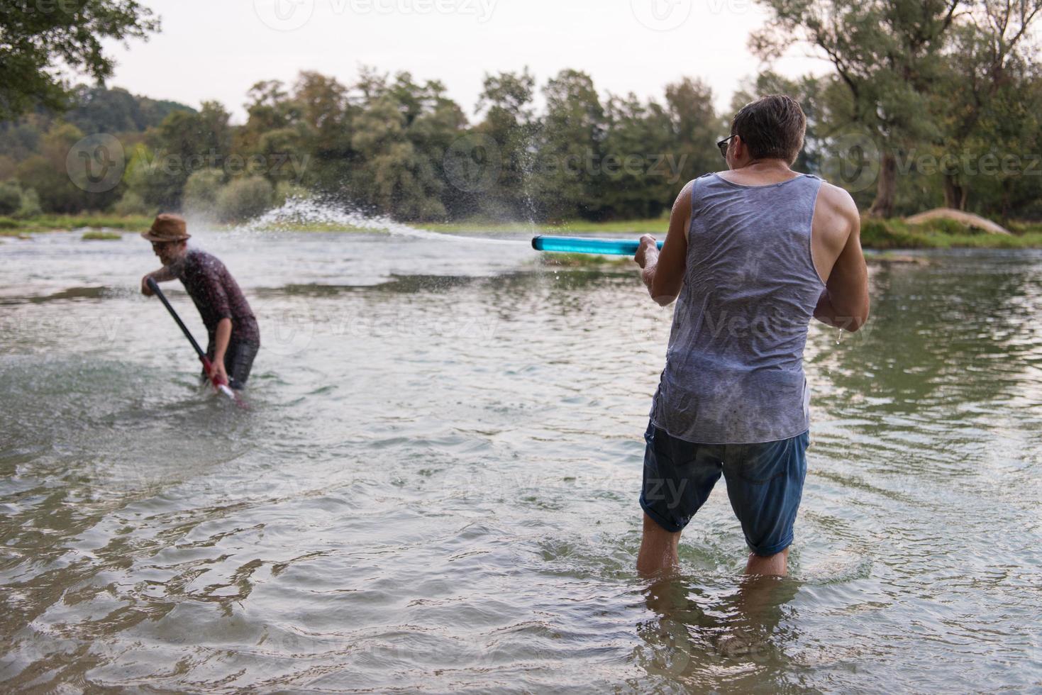 young men having fun with water guns photo