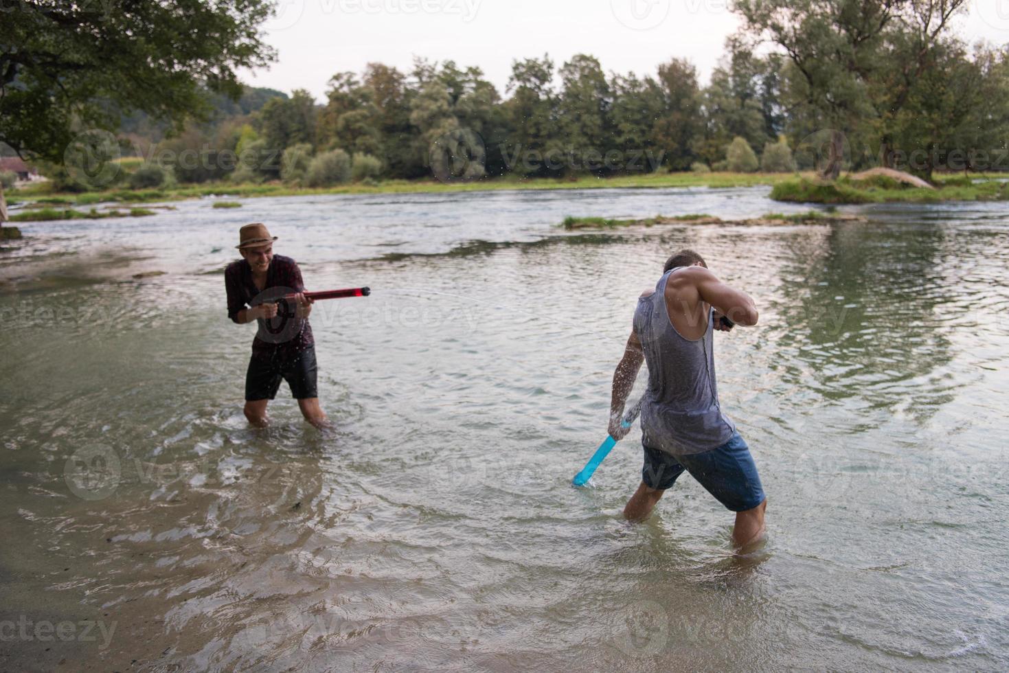 young men having fun with water guns photo