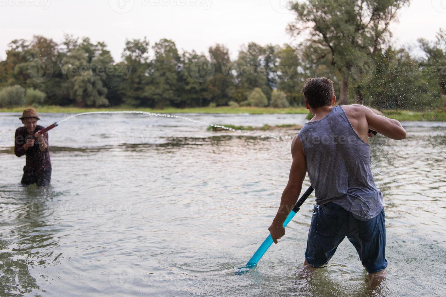 young men having fun with water guns photo