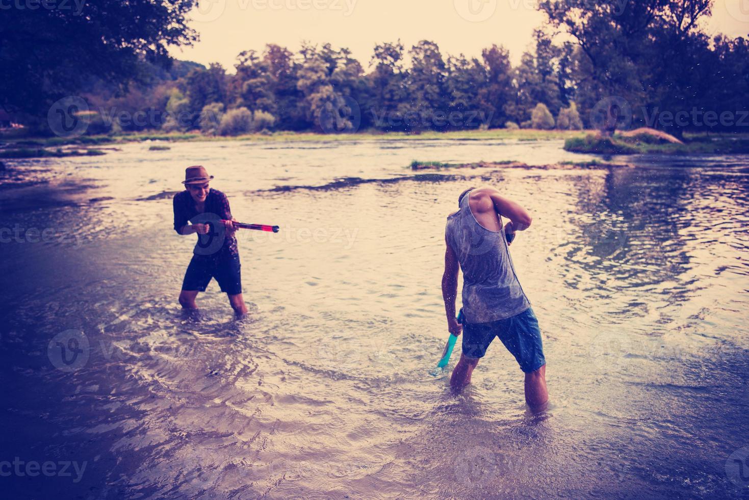 young men having fun with water guns photo