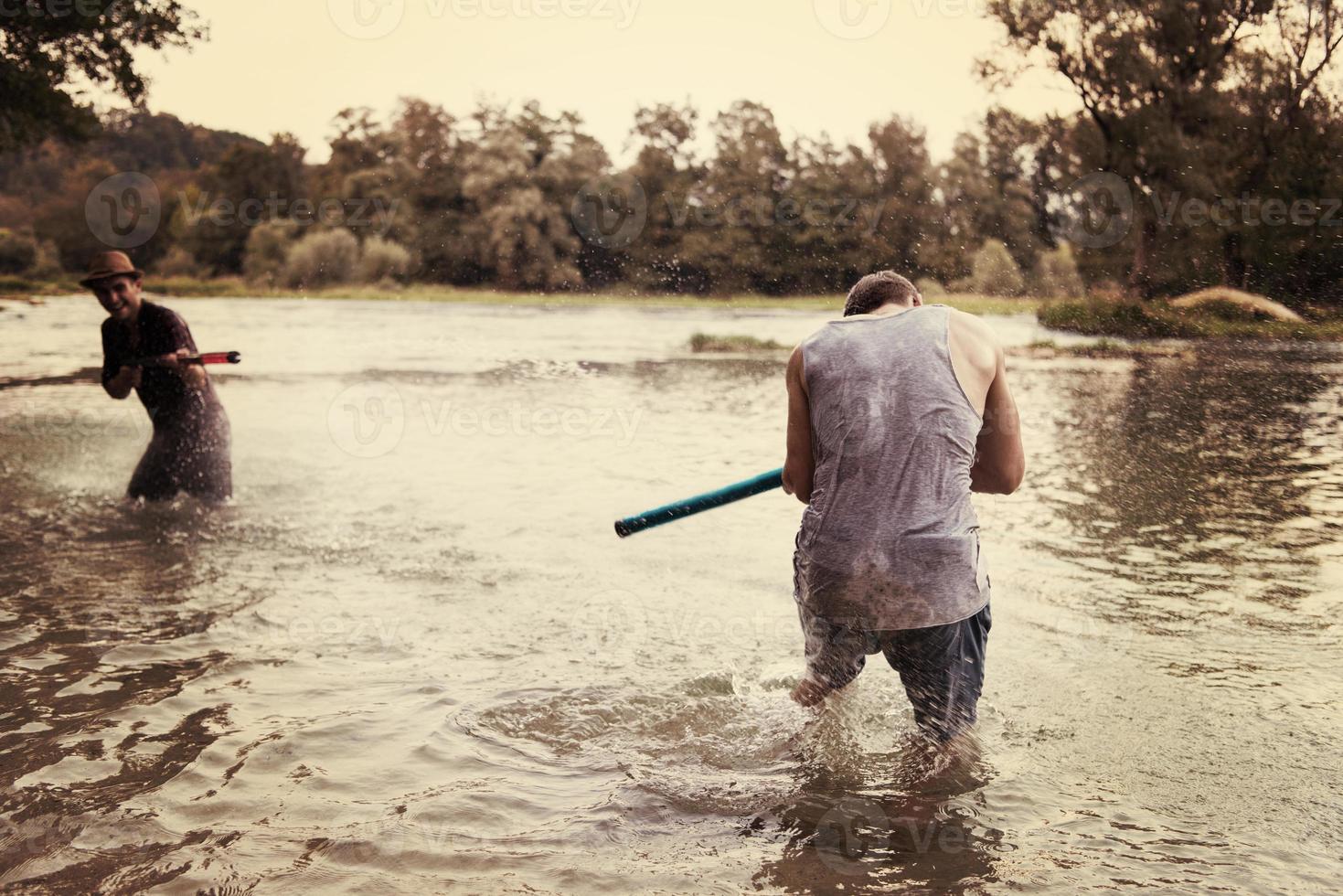 young men having fun with water guns photo