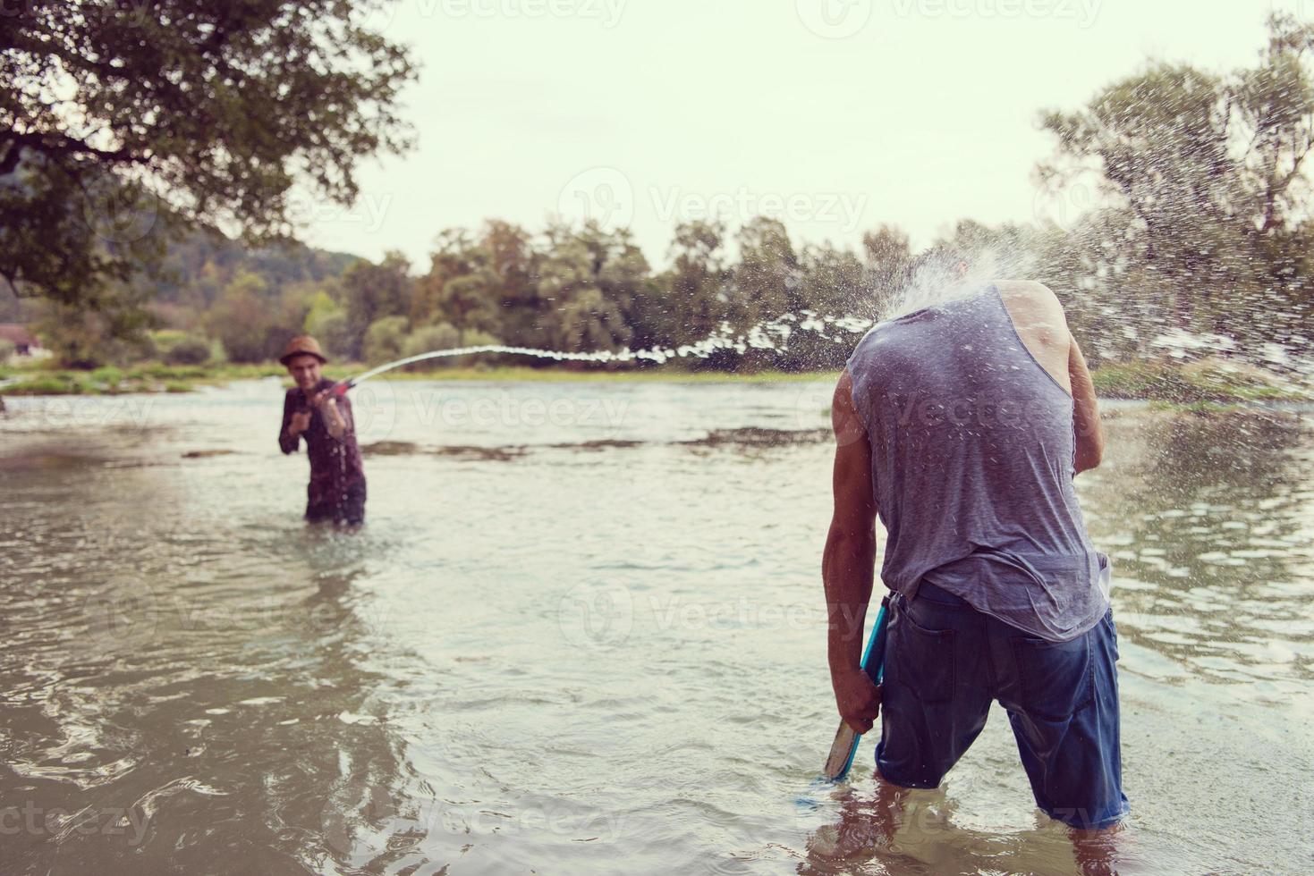 young men having fun with water guns photo