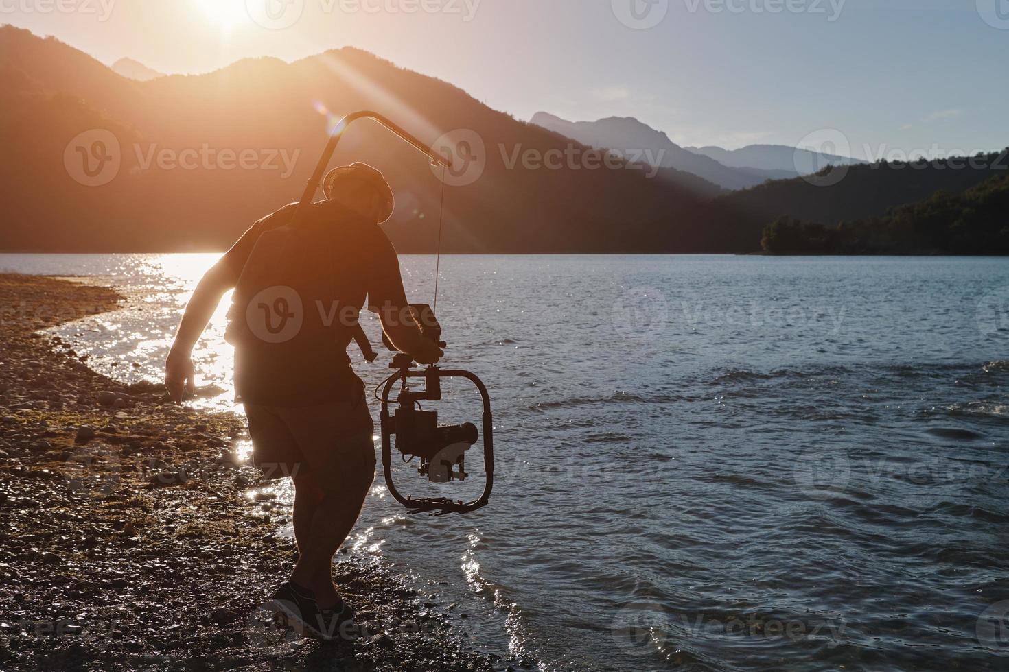 videographer  taking action shot of triathlon swimming athlete photo