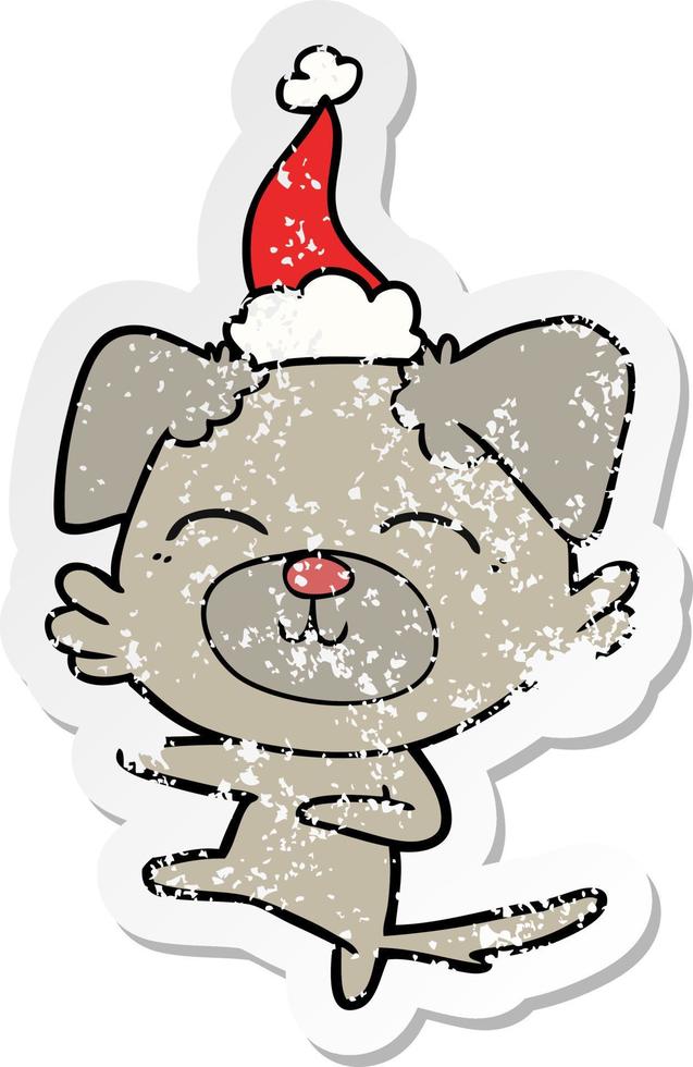 distressed sticker cartoon of a dog kicking wearing santa hat vector