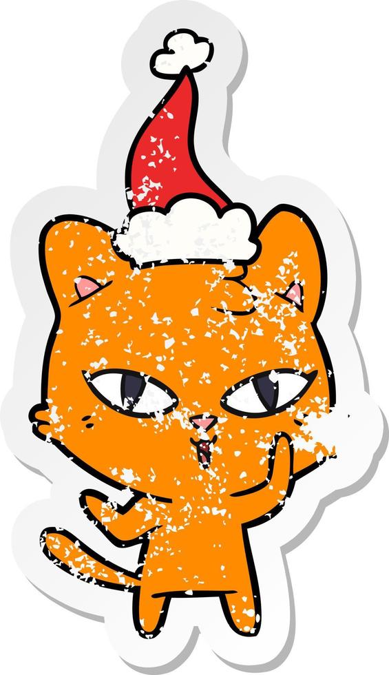 distressed sticker cartoon of a cat wearing santa hat vector