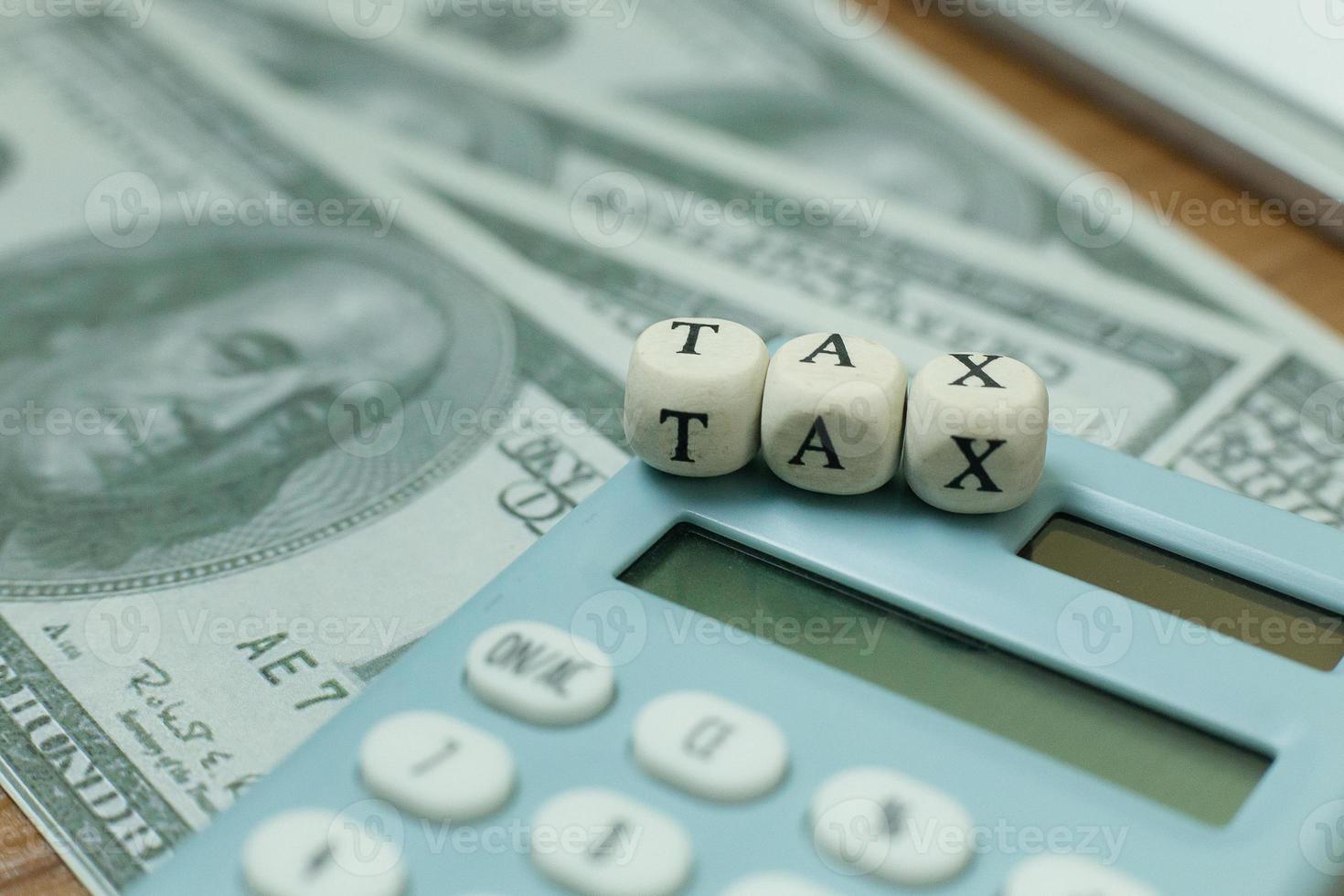 Tax wooden cubic on work table for business content. photo