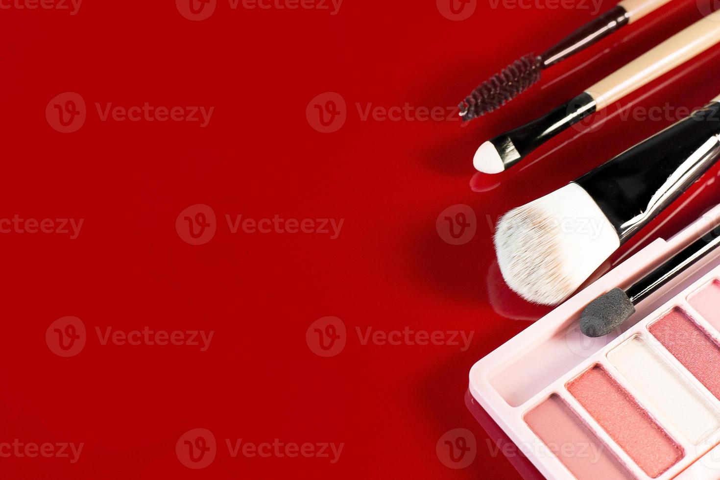 The cosmetics  on red glossy plate top view image.he cosmetics  on red glossy plate photo