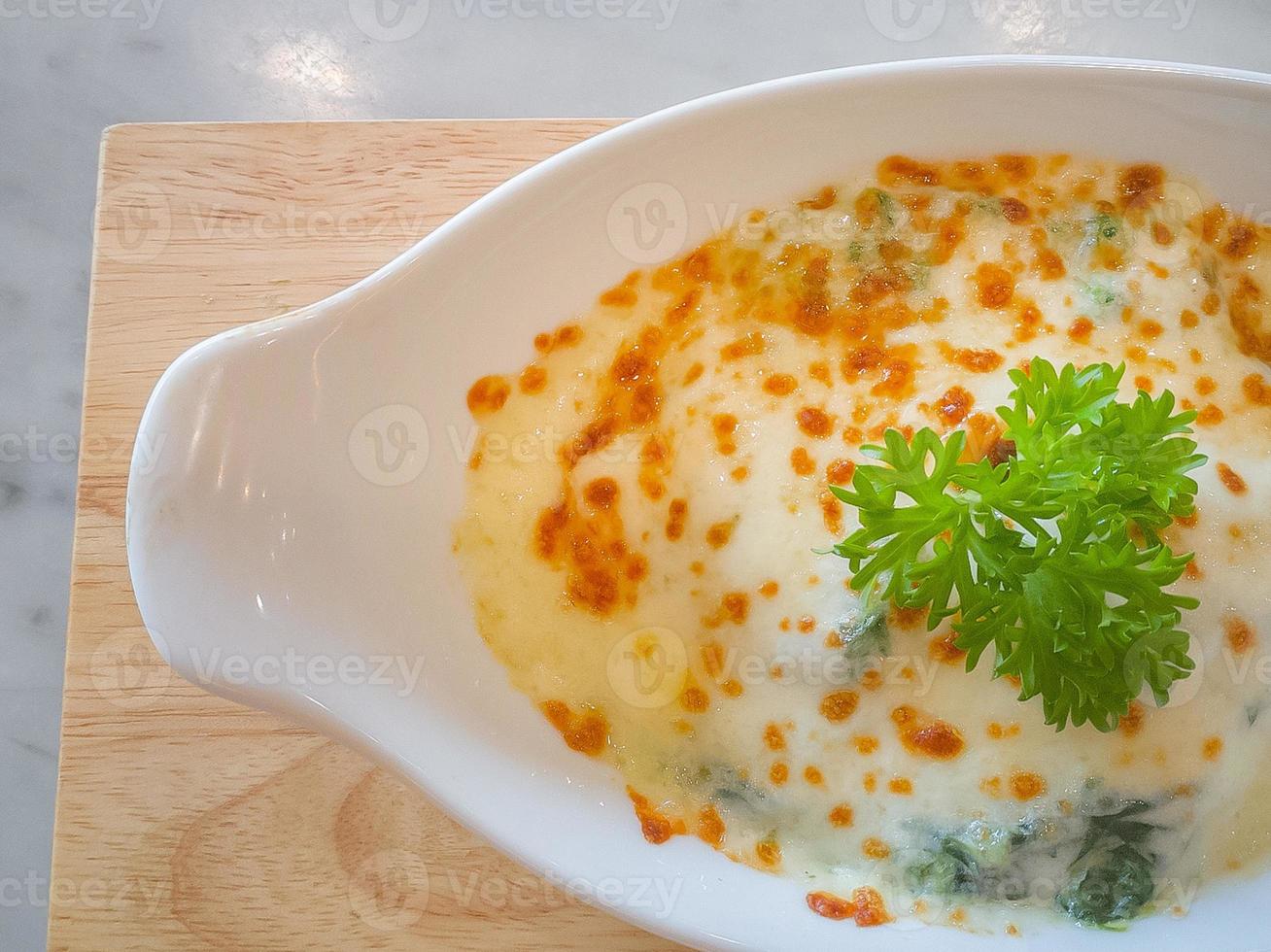 Spinach with cheese in white bowl on wood plate  Flat Lay image. photo
