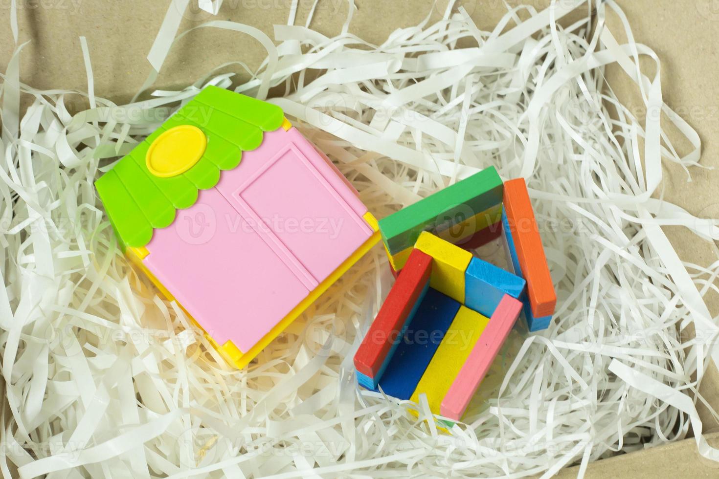 Toy home on Cushioning paper in box for home business content. photo