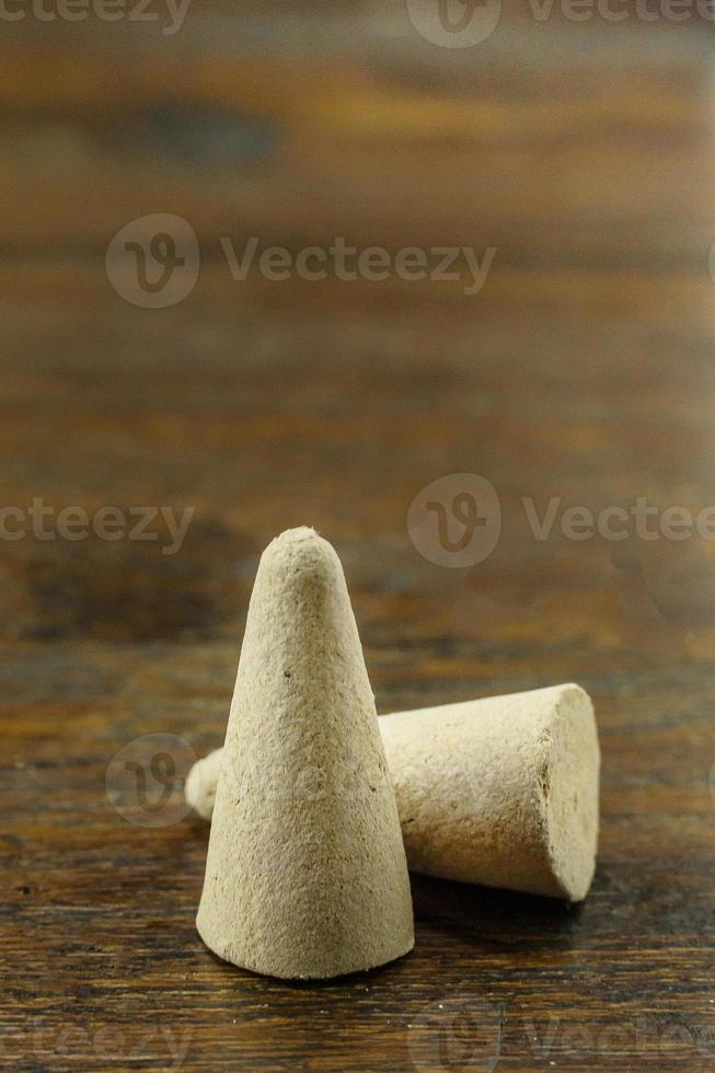 Incense Cone in a stand with the feather for background. photo