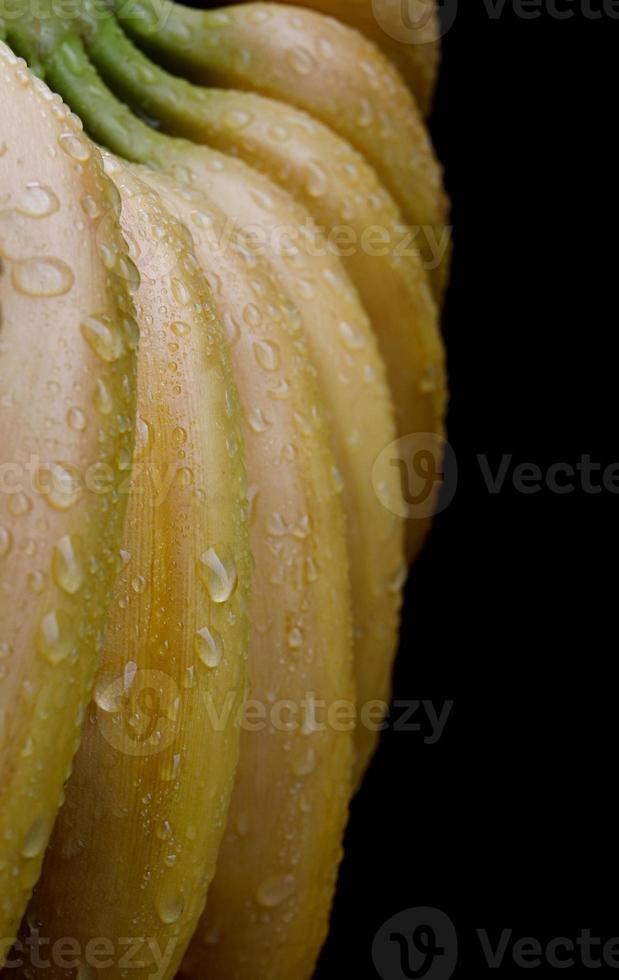 Bunch of bananas with drops of water on the peel. photo