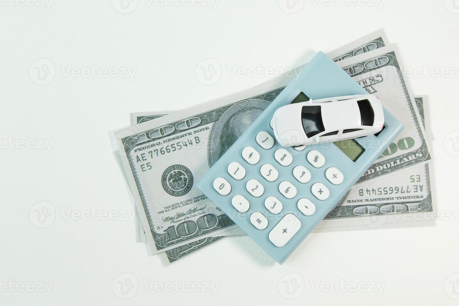 white car toy and blue calculator white background. photo