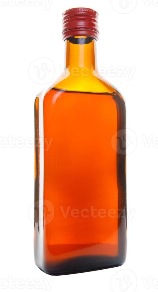 A beautiful glass bottle with a red lid is isolated on a white background. photo