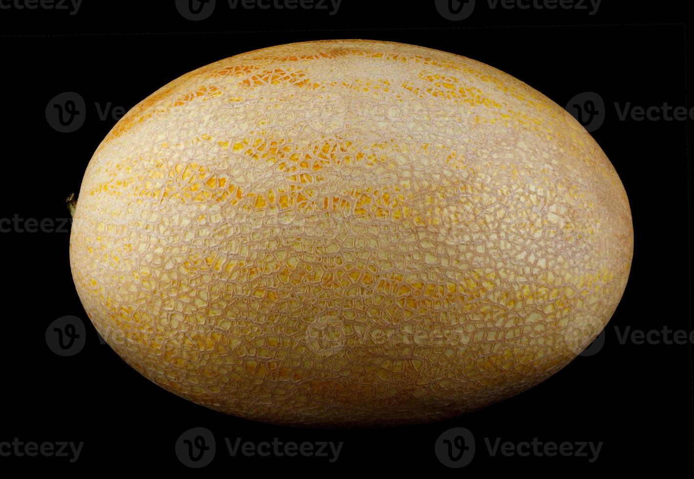 The yellow ripe melon is isolated on a black background. photo