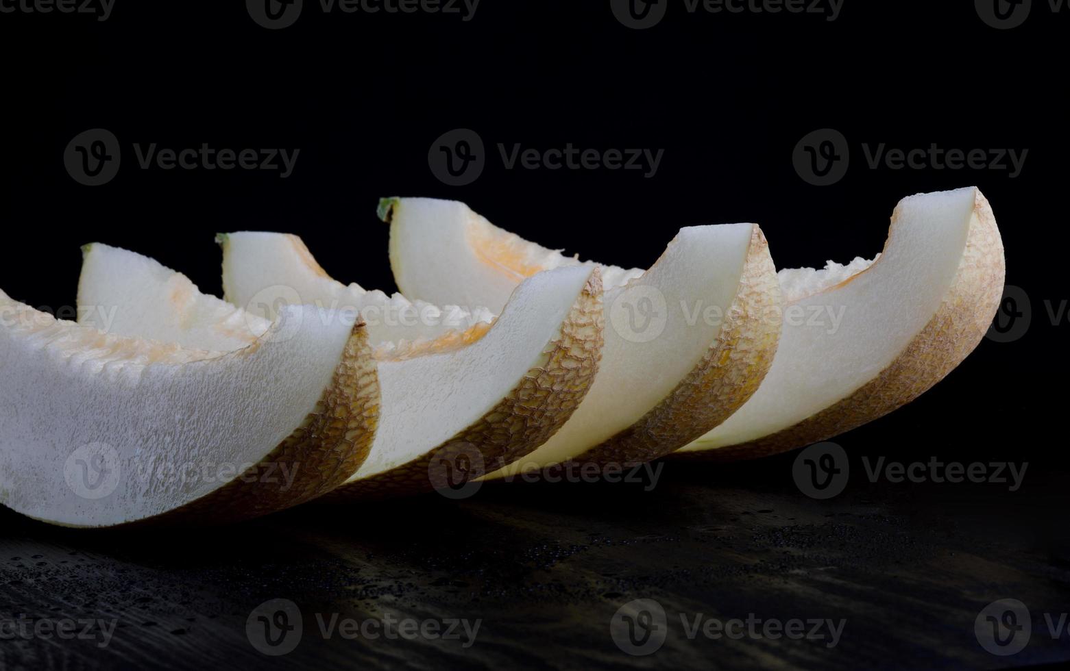 Ripe juicy melon cut into several lobes. photo