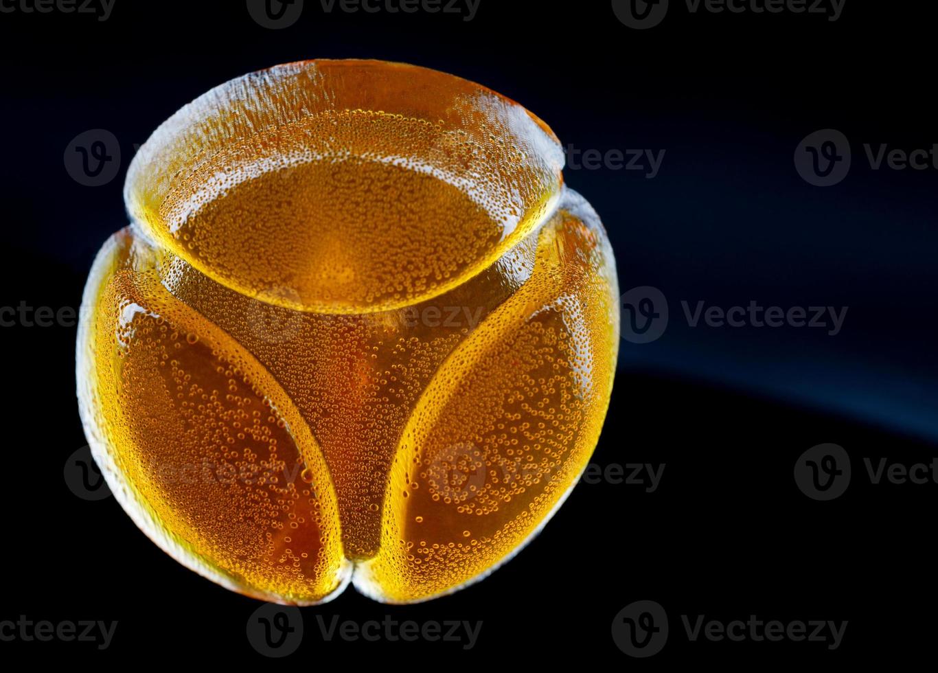 Beautiful yellow marmalade candy is isolated on a black background. photo