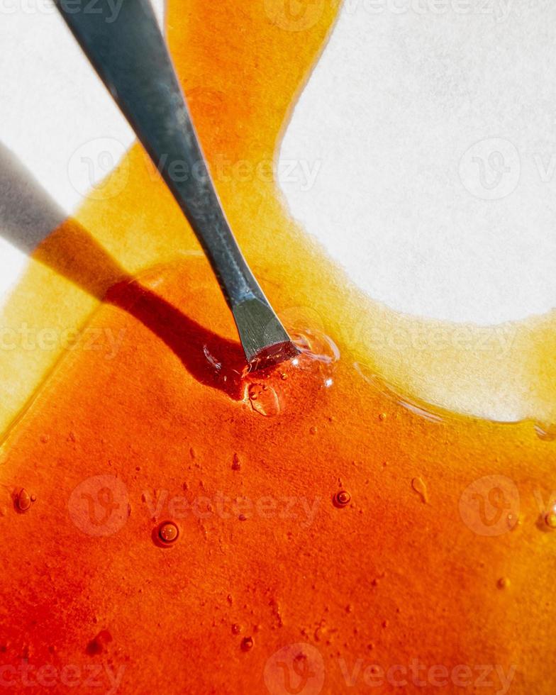 cannabis golden extract oil, metal stick and wax high thc photo