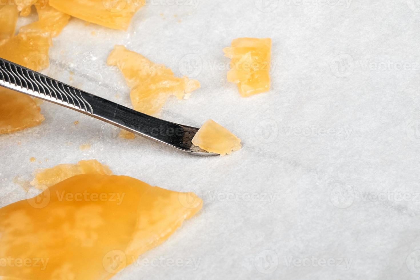yellow orange cannabis concentrate wax close up, high thc dab resin photo