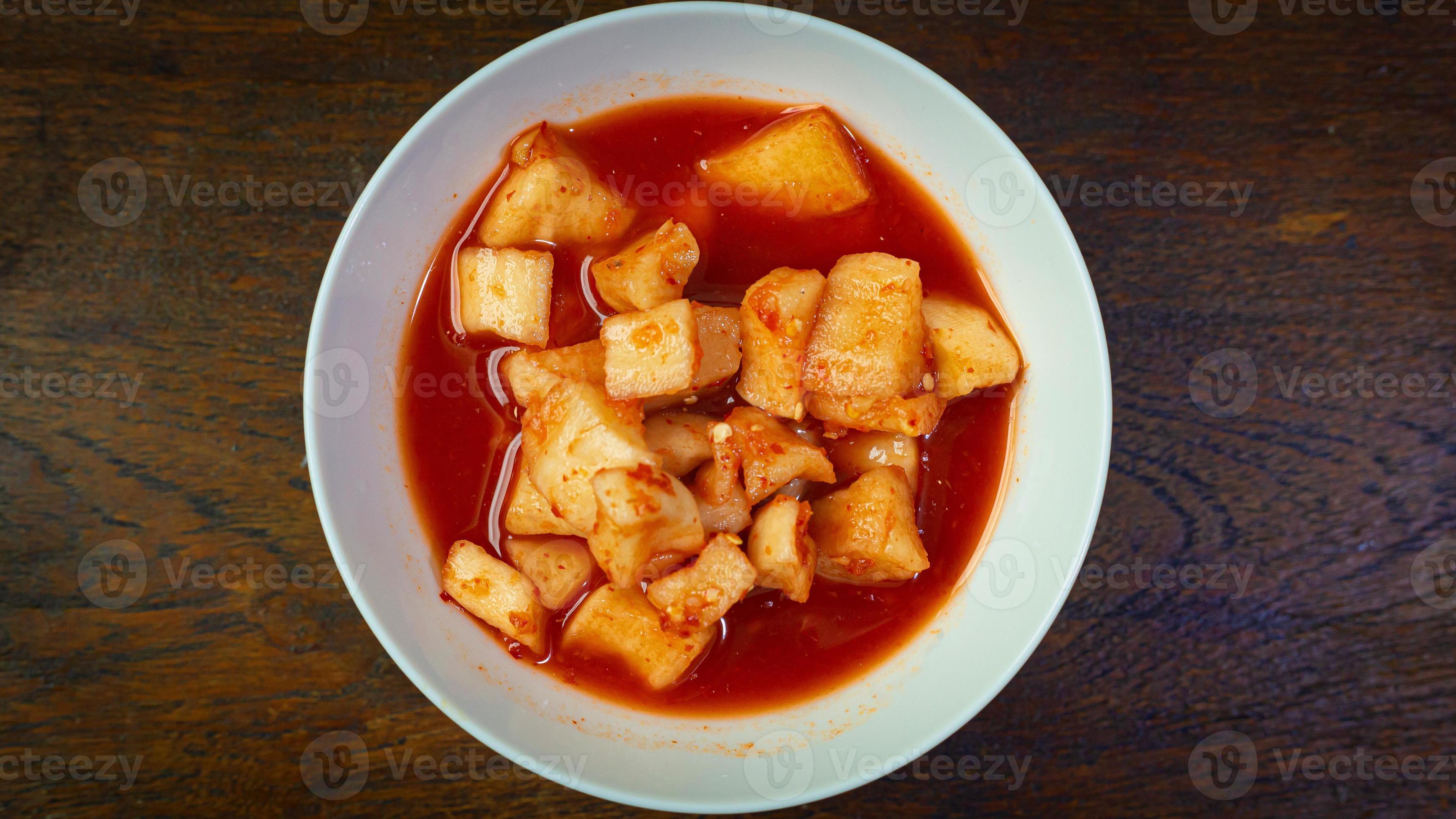 Korean Radish Kimchi in white bowl on wood table for food content. 10695732 Stock Photo at Vecteezy