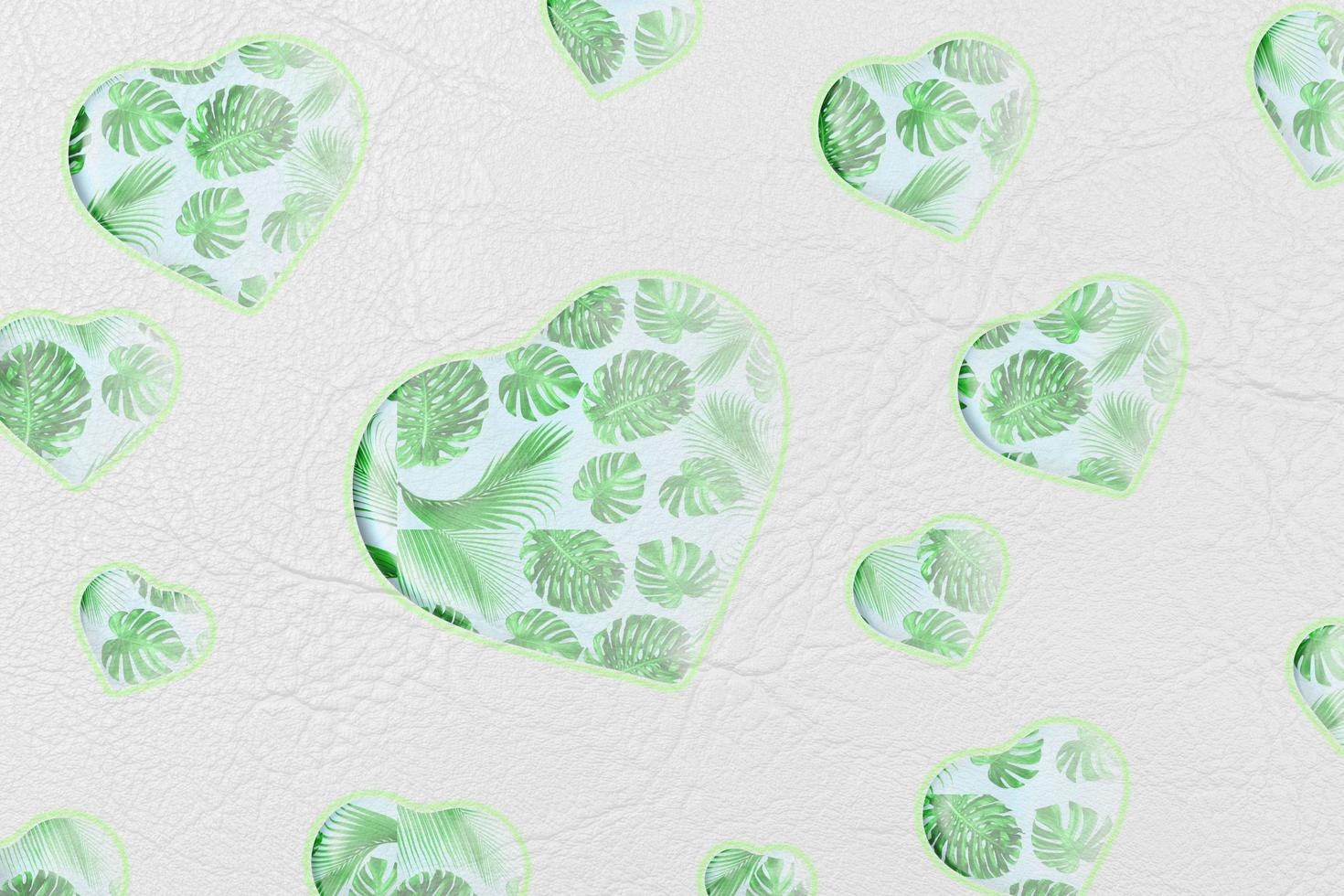Abstract green heart isolated on white leather or paper texture with palm leaves pattern background,valentine day and love concept. photo