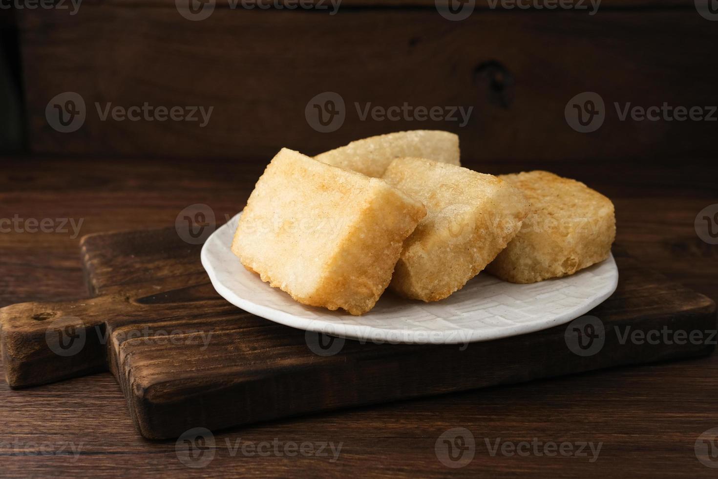 Jadah Goreng or Fried sticky rice cake is Javanese traditional cake made from glutinous rice and grated coconut. Served in white plate photo
