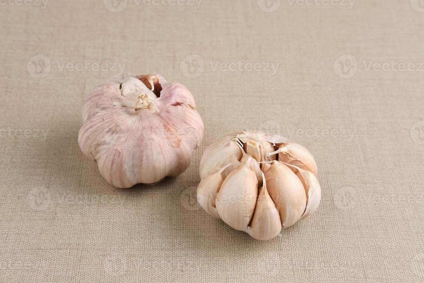 Lots of fresh garlic on bamboo basket. Close up and copy space. photo