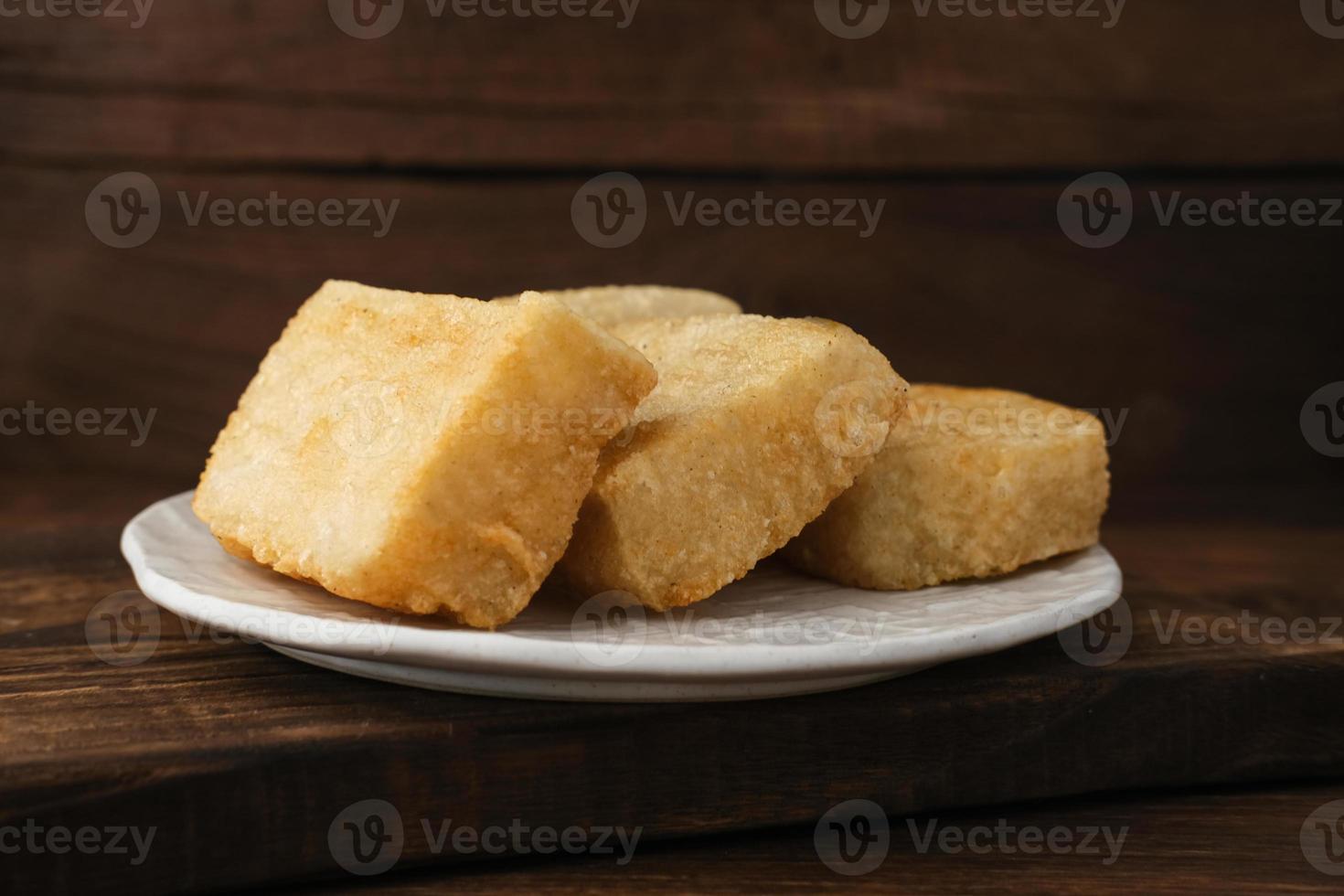 Jadah Goreng or Fried sticky rice cake is Javanese traditional cake made from glutinous rice and grated coconut. Served in white plate photo