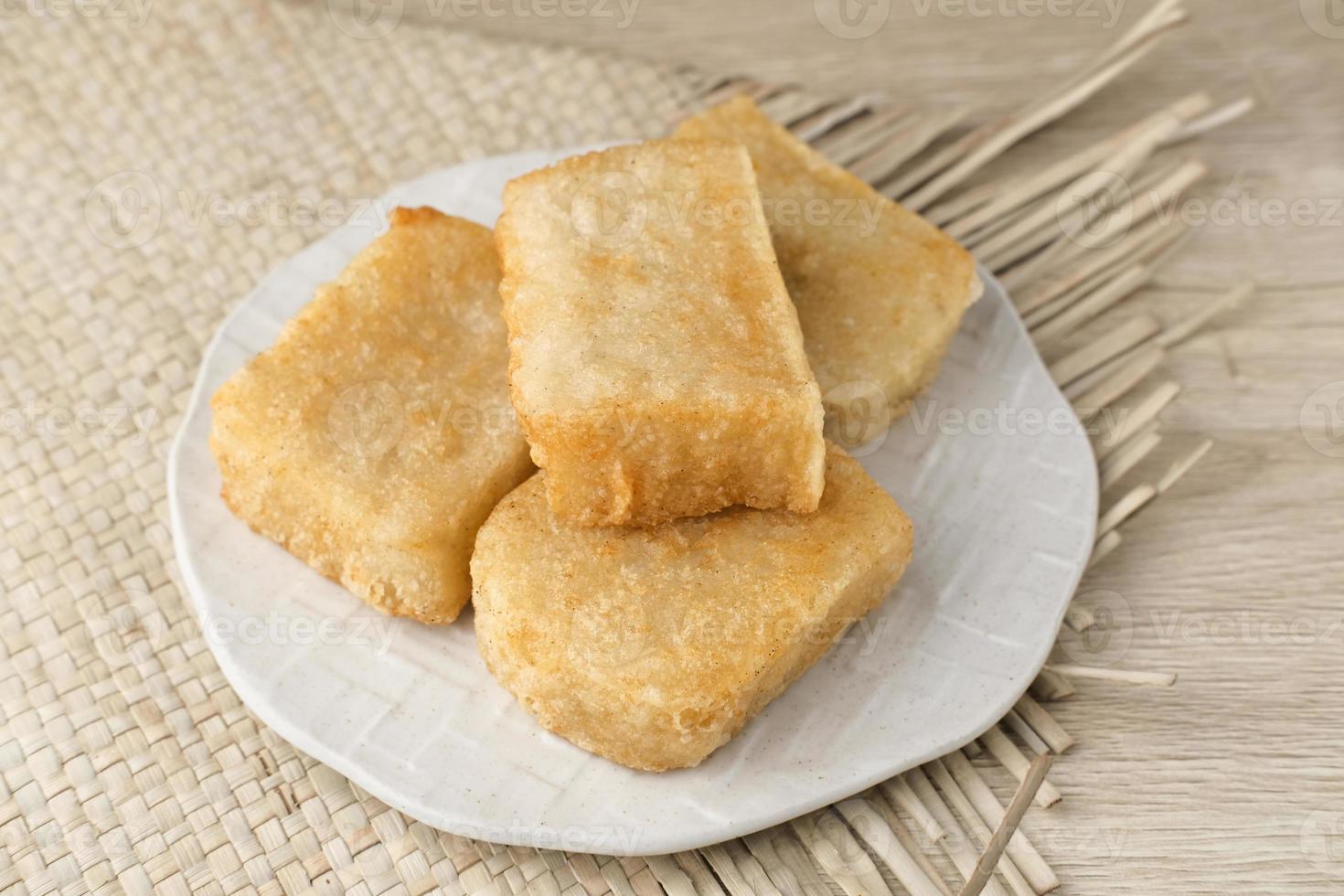 Jadah Goreng or Fried sticky rice cake is Javanese traditional cake made from glutinous rice and grated coconut. Served in white plate photo