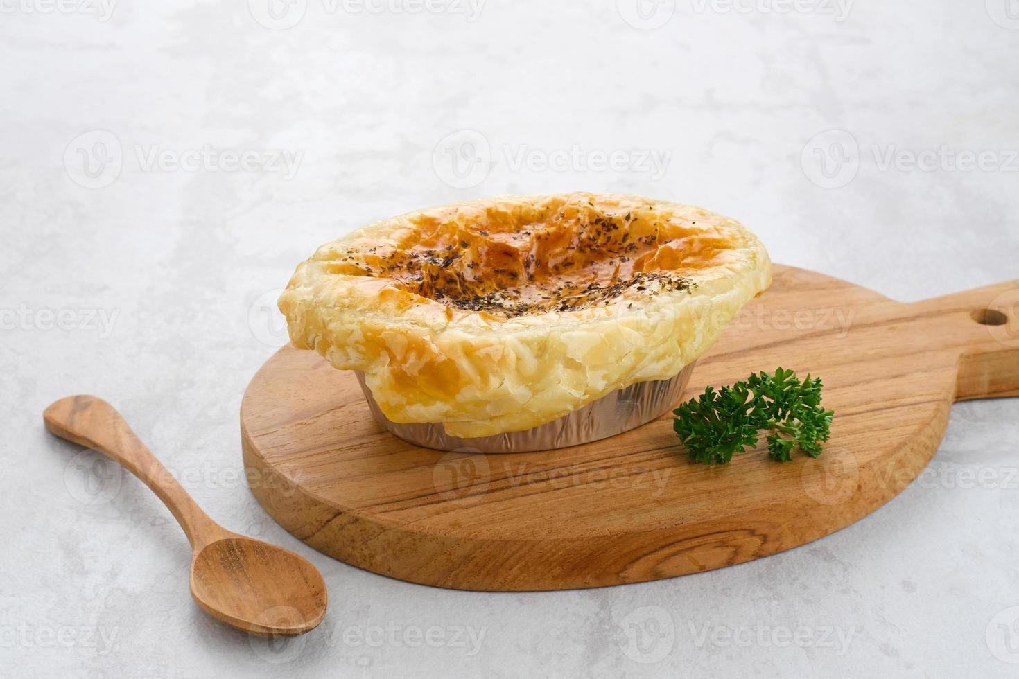 Zuppa Soup, a thick and creamy soup with puff pastry placed on top like a hat, contains corn, carrots and chicken. photo