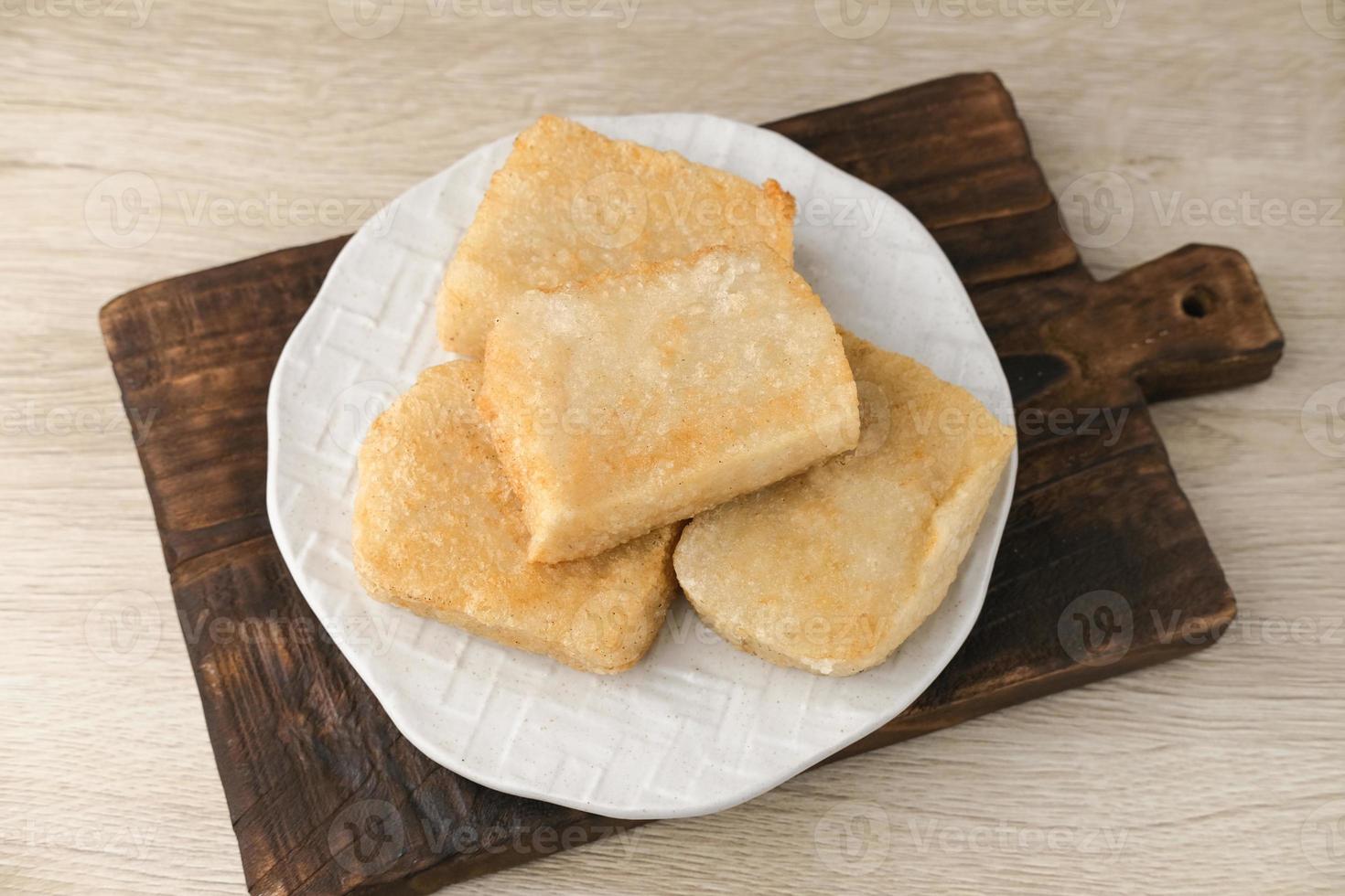 Jadah Goreng or Fried sticky rice cake is Javanese traditional cake made from glutinous rice and grated coconut. Served in white plate photo