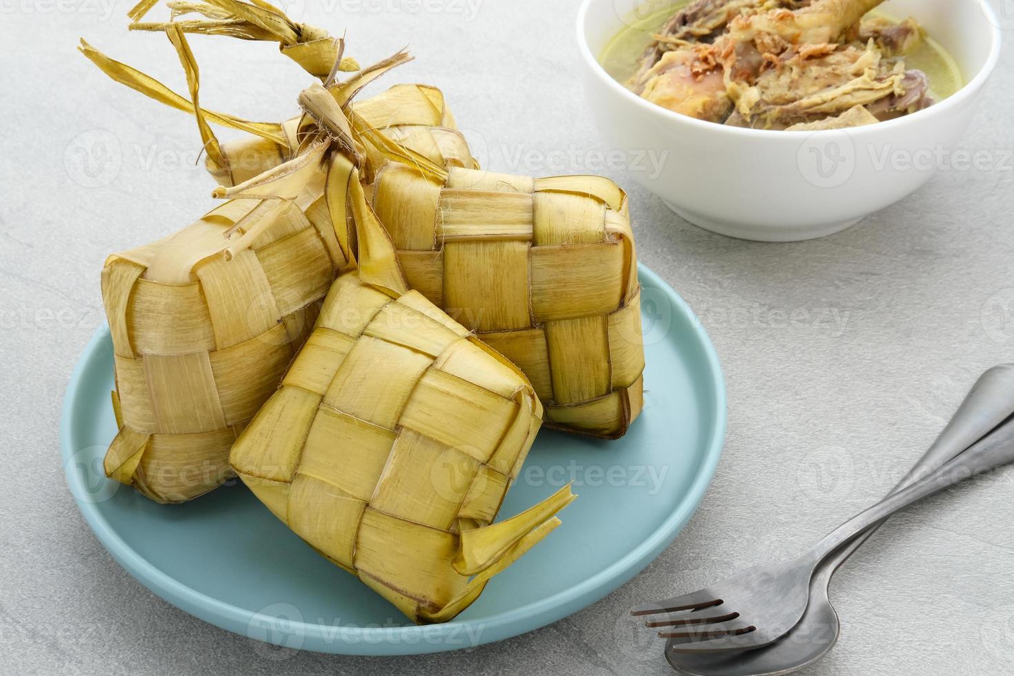 Ketupat, Ketupat or rice dumpling is a local delicacy during Eid al-Fitr. Natural rice casing made from young coconut leaves for cooking rice.  It is very popular during Eid al-Fitr in Indonesia. photo