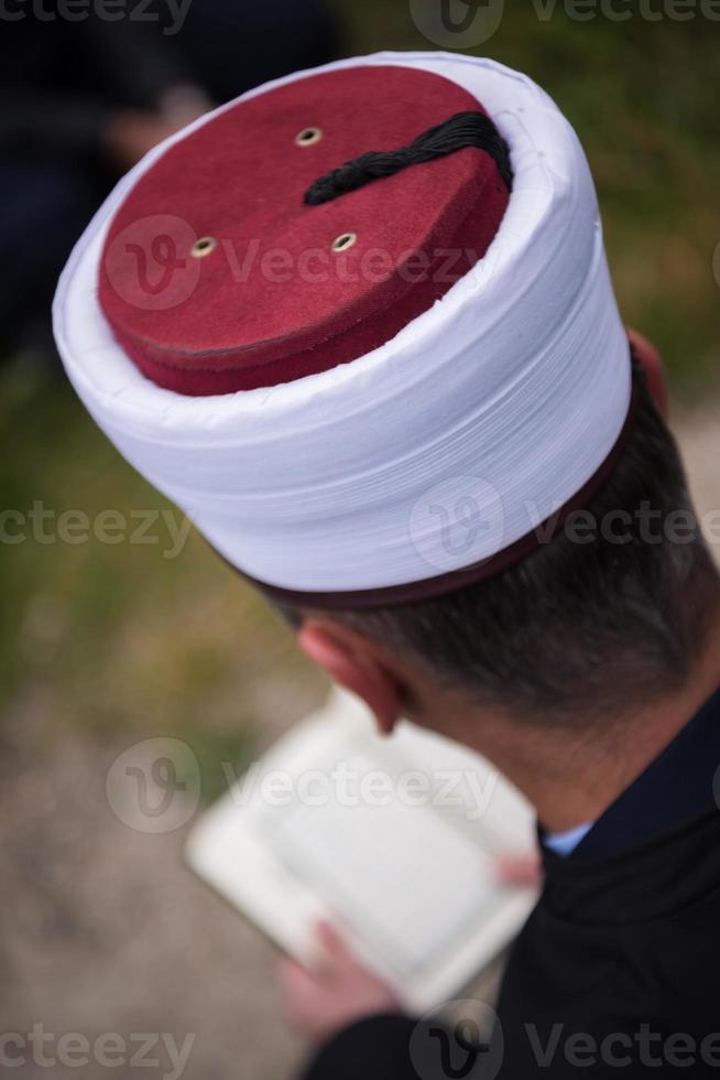 quran holy book reading by imam  on islamic funeral photo