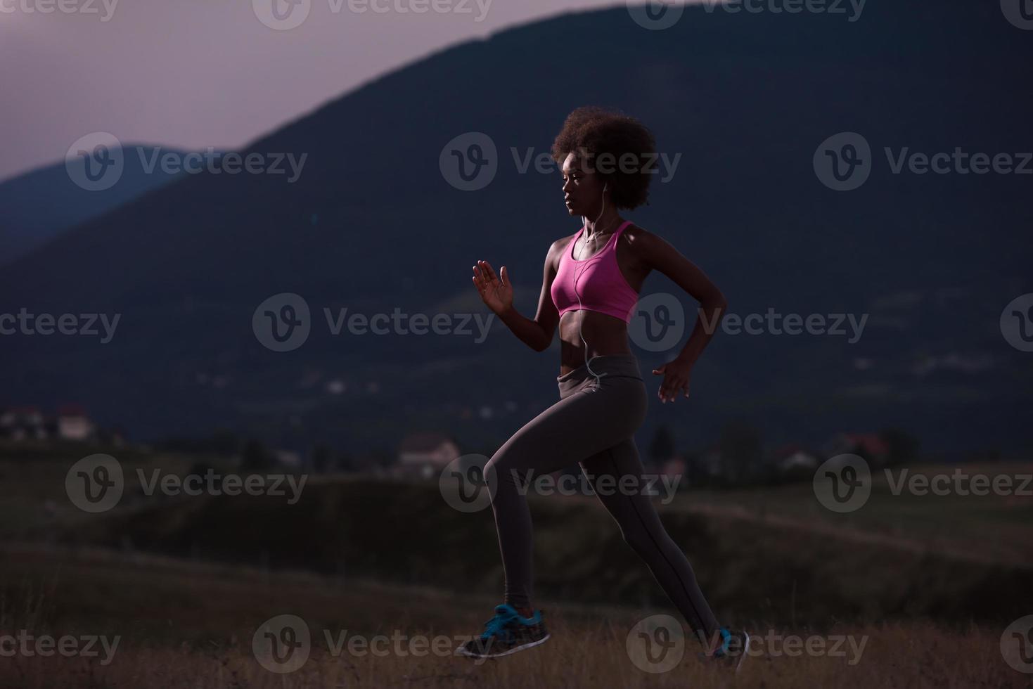 Young African american woman jogging in nature photo