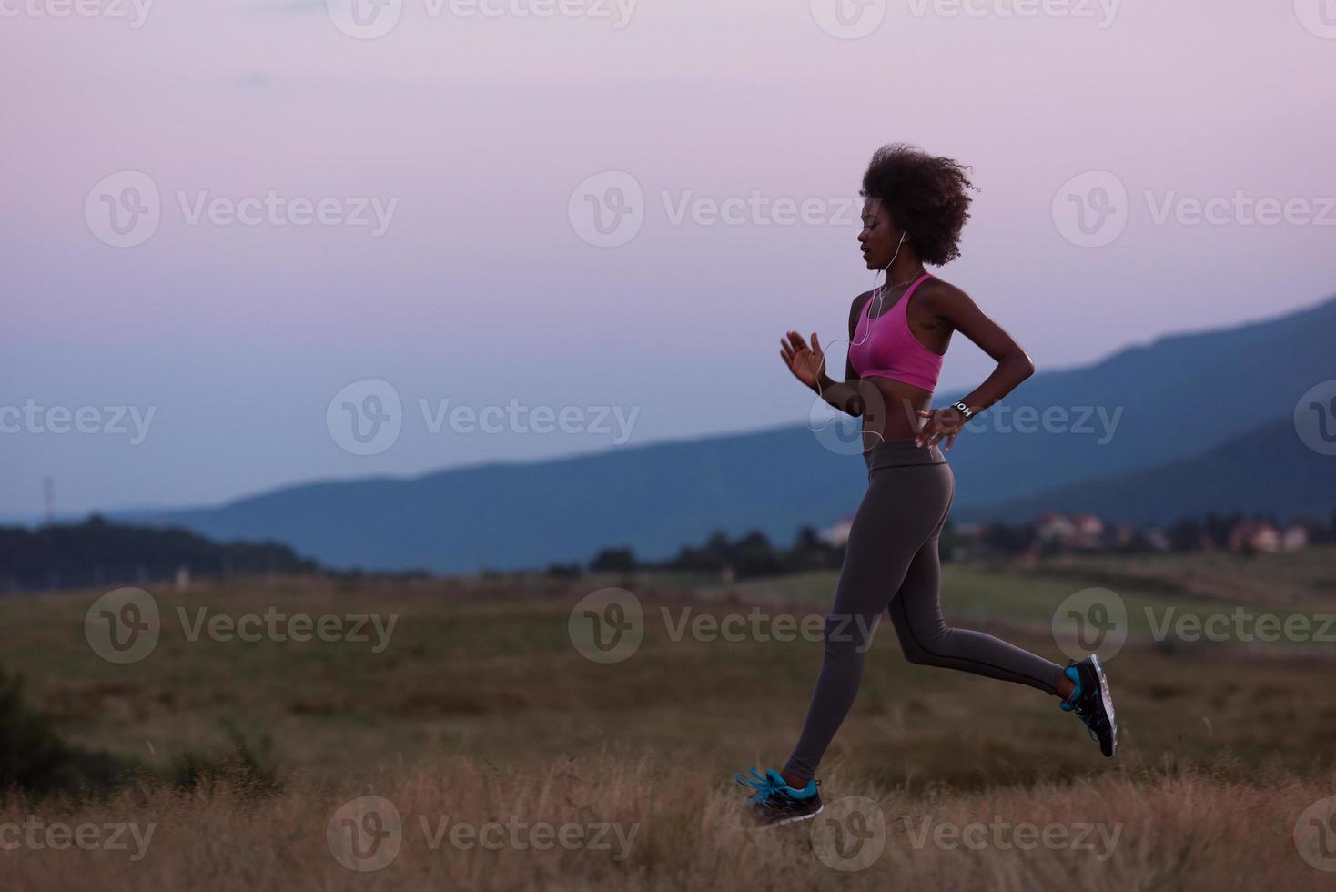 Young African american woman jogging in nature photo
