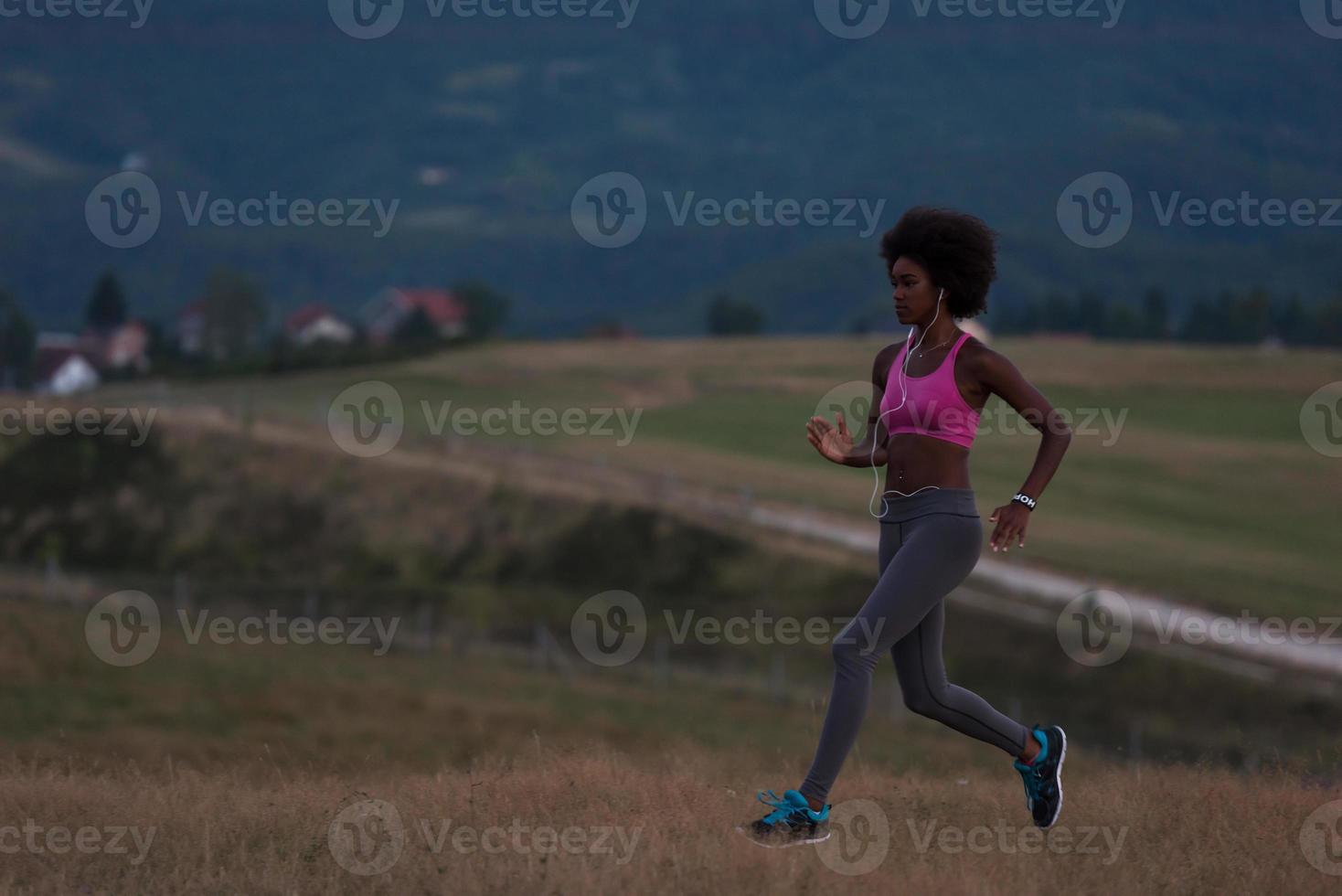 Young African american woman jogging in nature photo