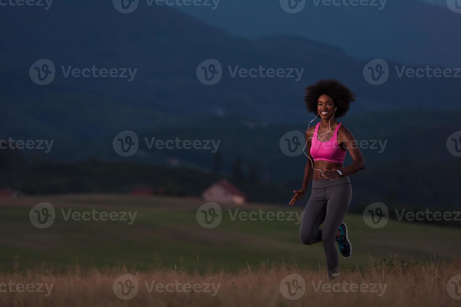 Young African american woman jogging in nature photo