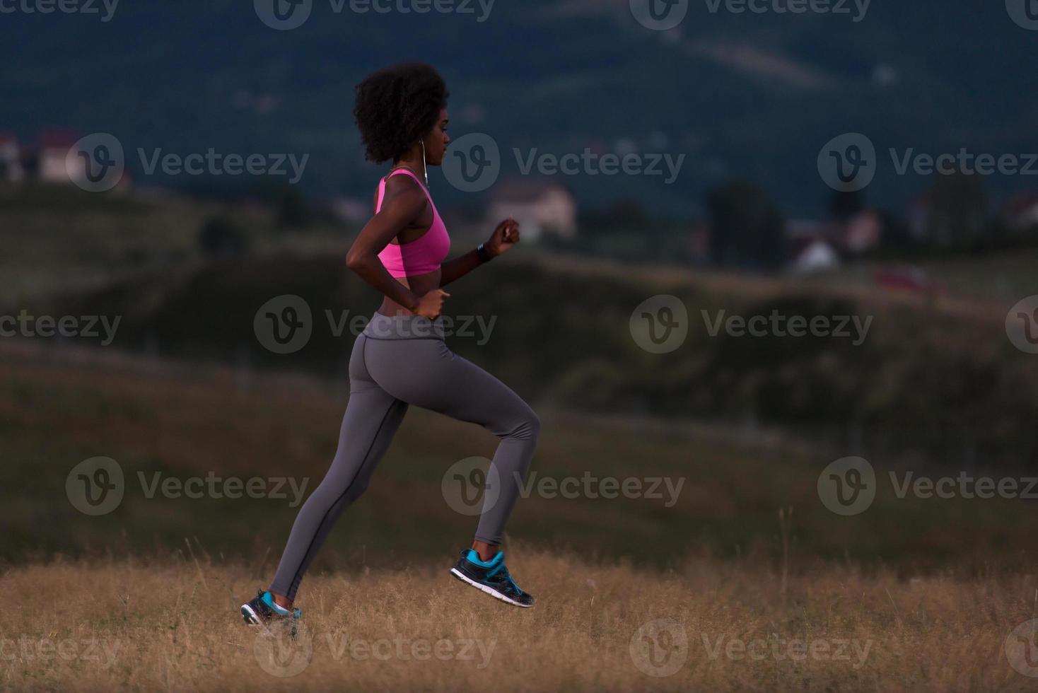 Young African american woman jogging in nature photo