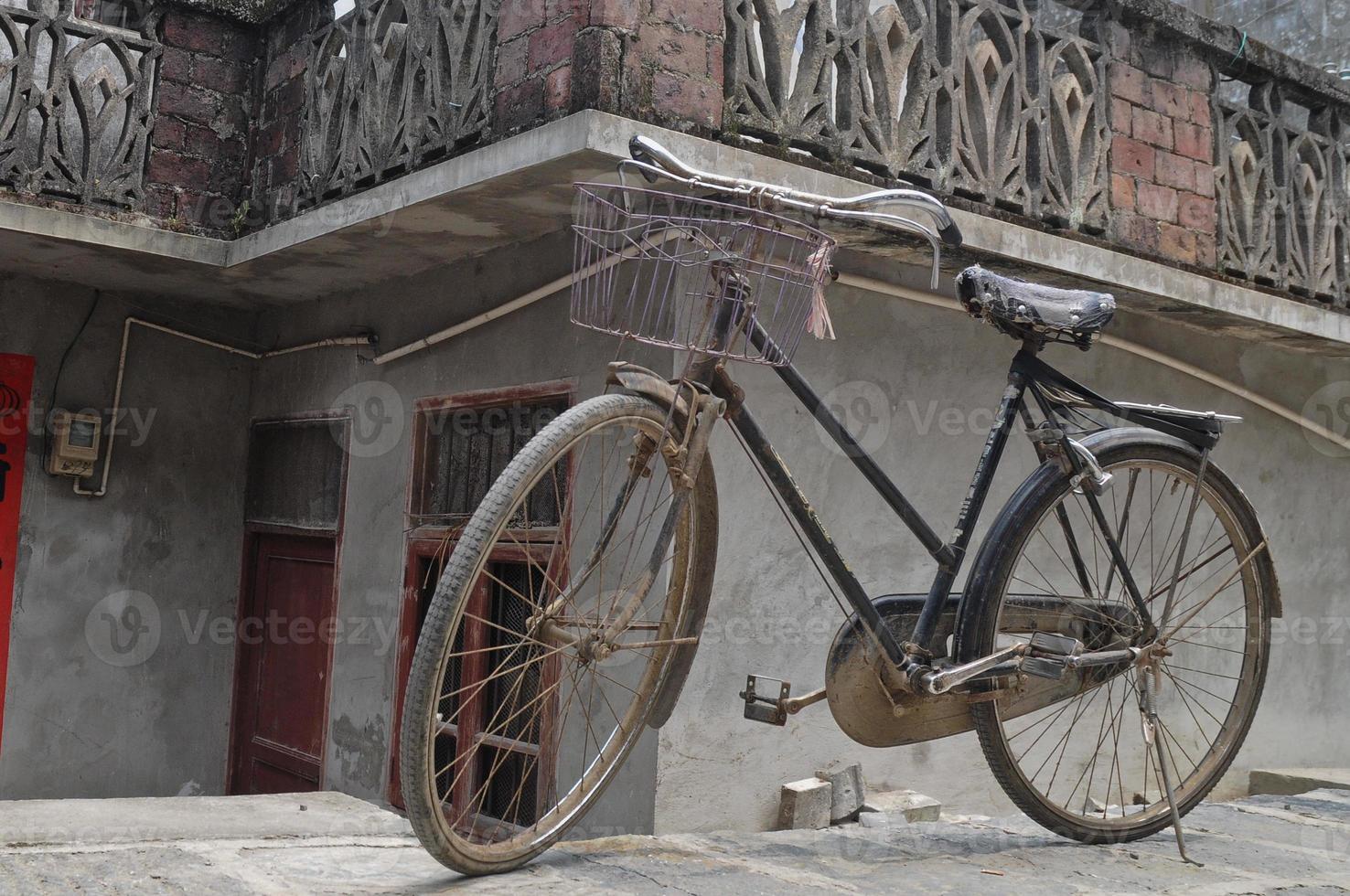 Rustic vintage bicycle in old town China photo