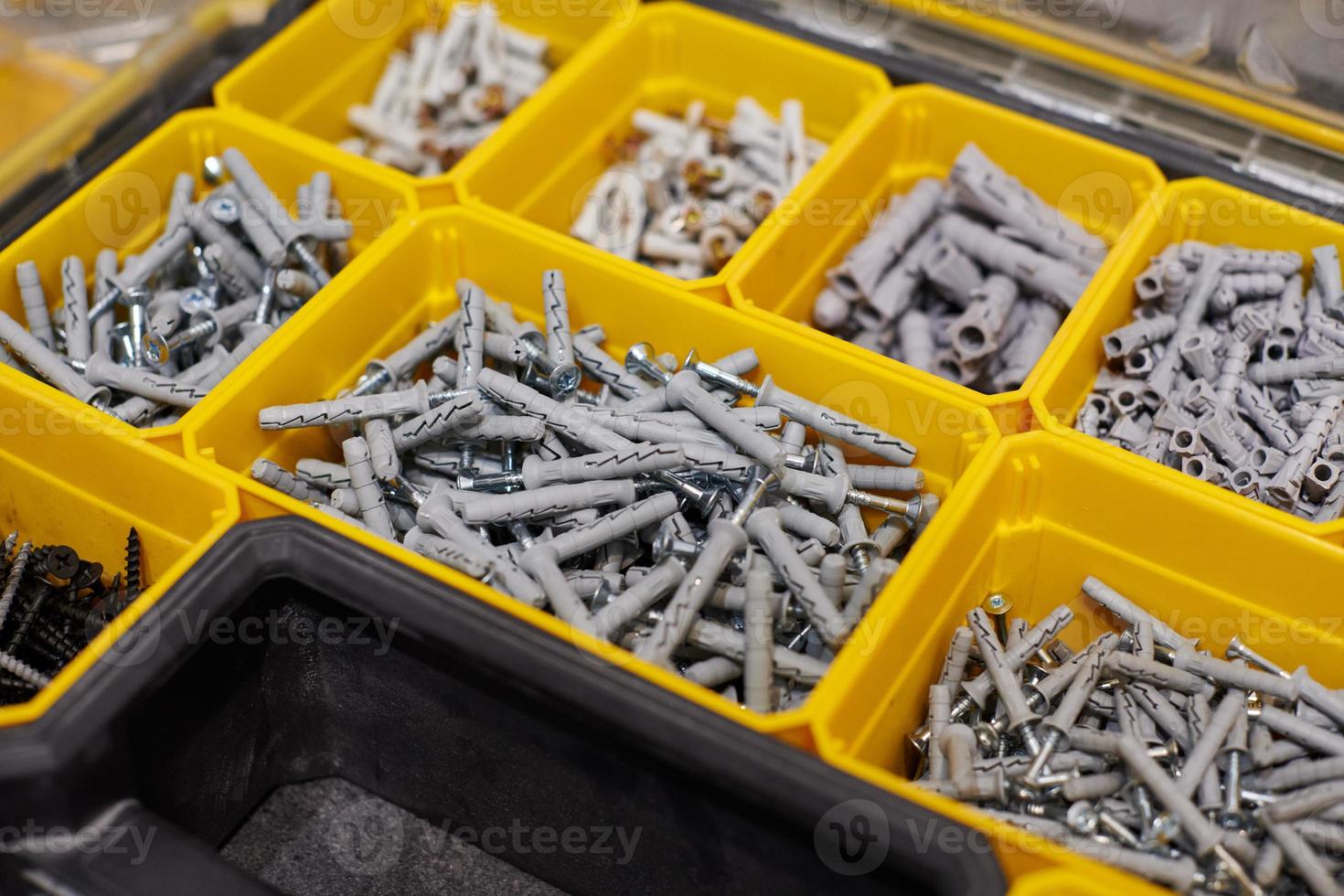 Storage case with screws, nuts, bolts, nails and other small tools for handyman, close up photo
