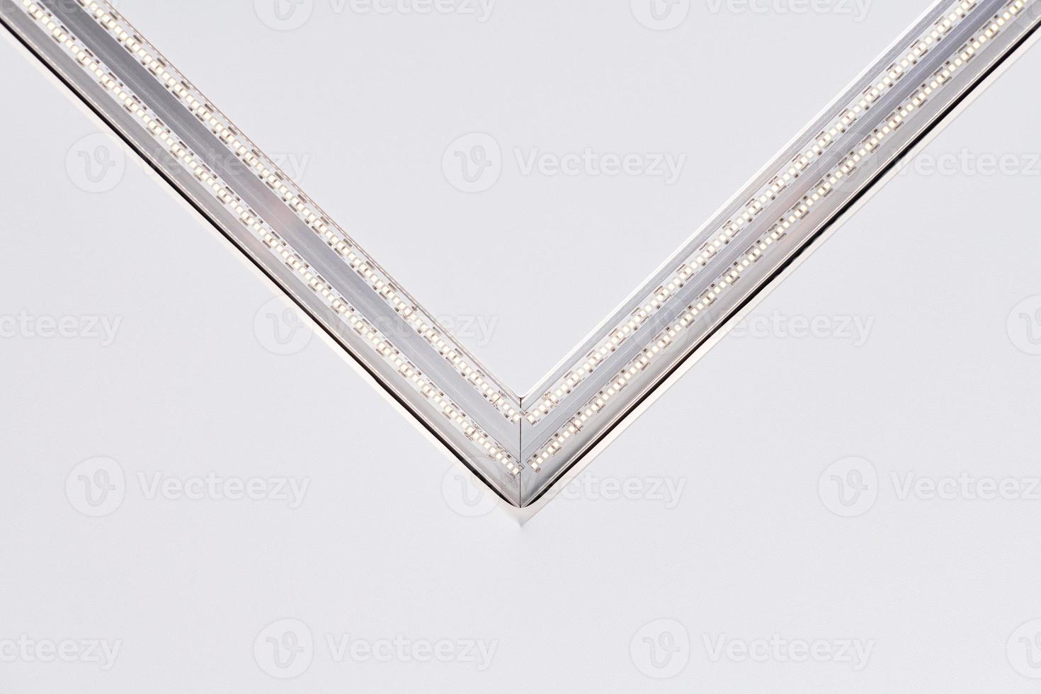 Strip LED lamp lighting with square aluminum profile on suspended ceiling in house, fragment, close photo