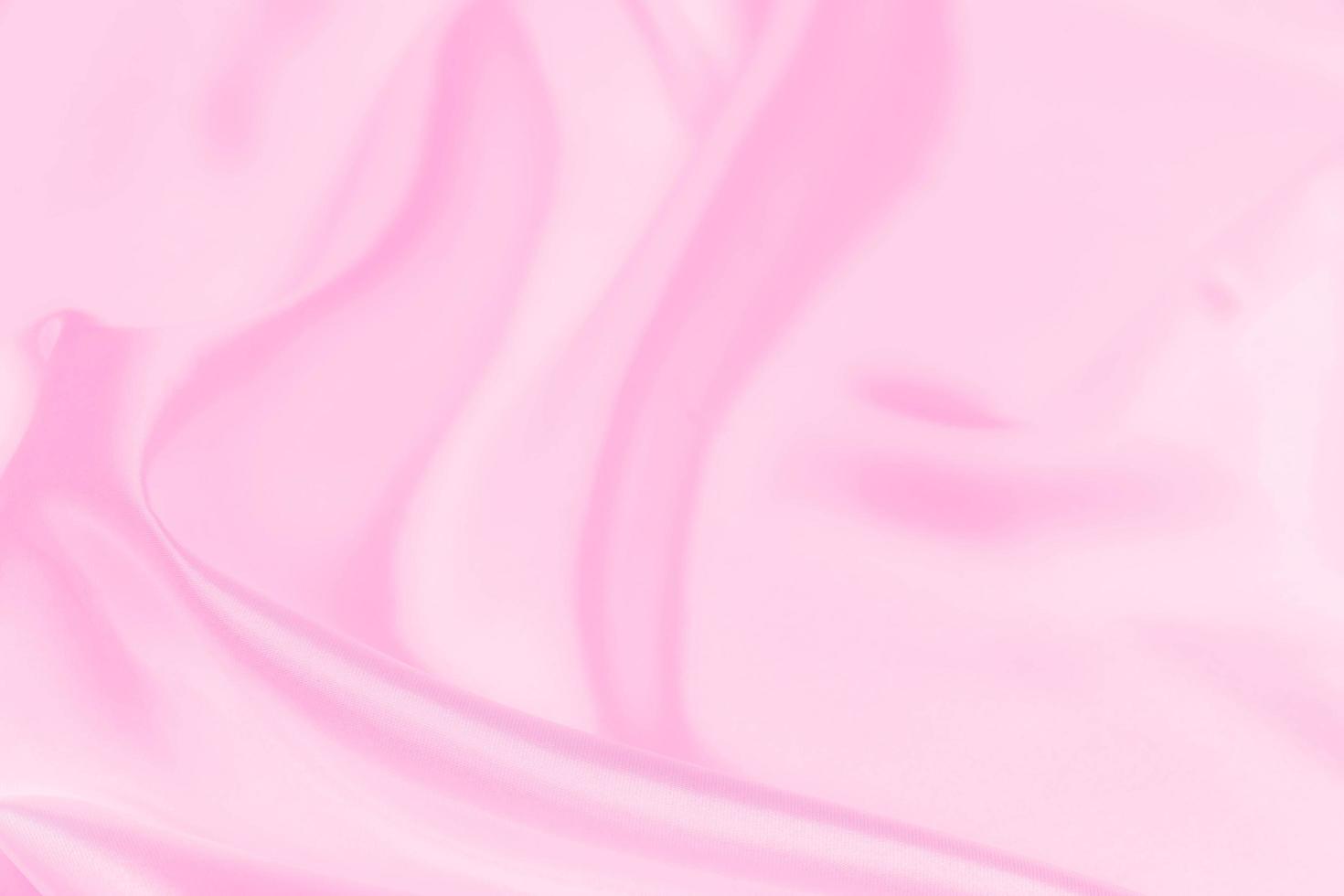 Plastic pink satin fabric texture soft blur background photo