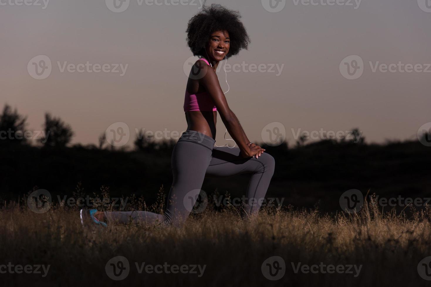 black woman is doing stretching exercise relaxing and warm up photo