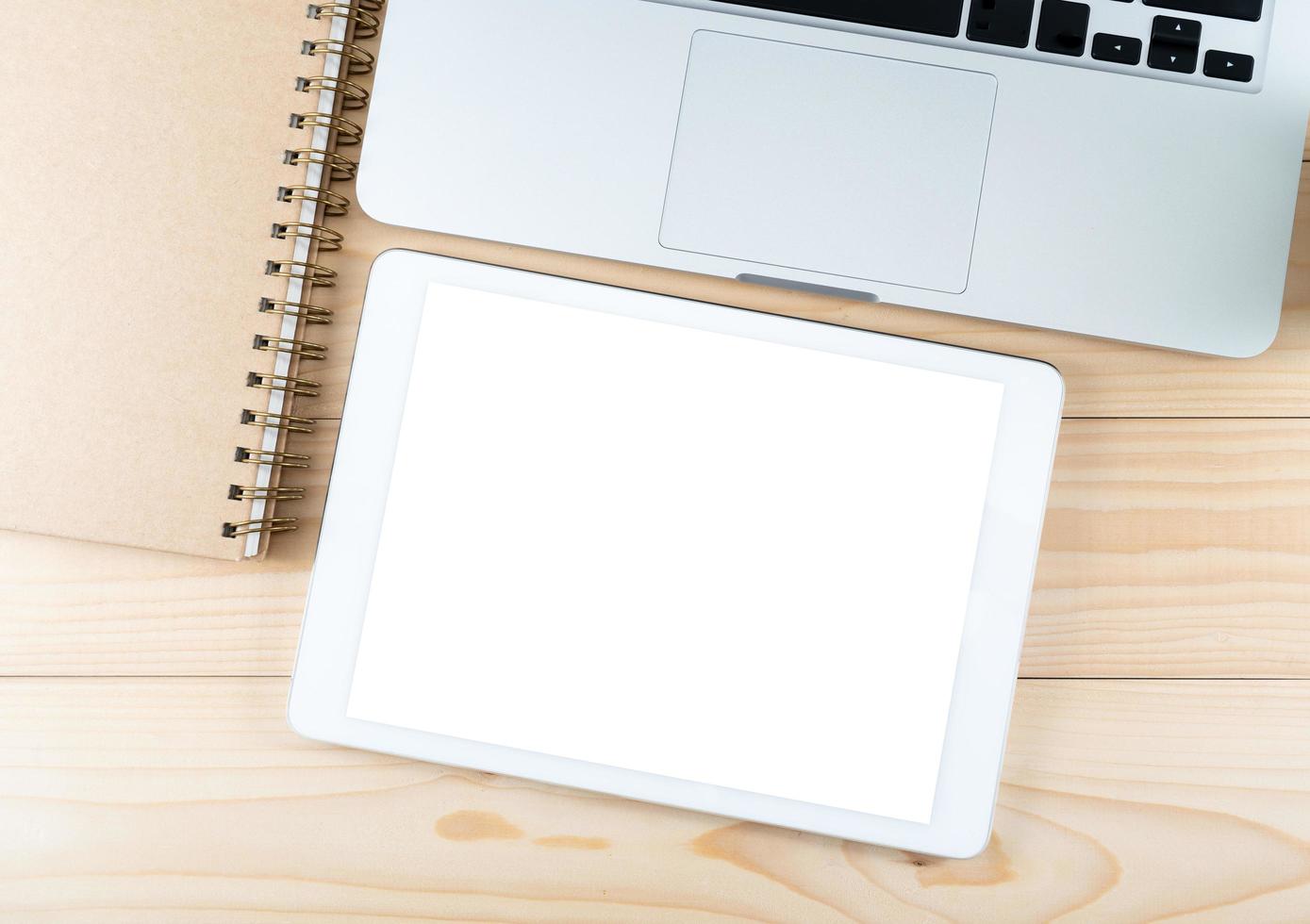 Office table top view and tablet with blank white screen photo