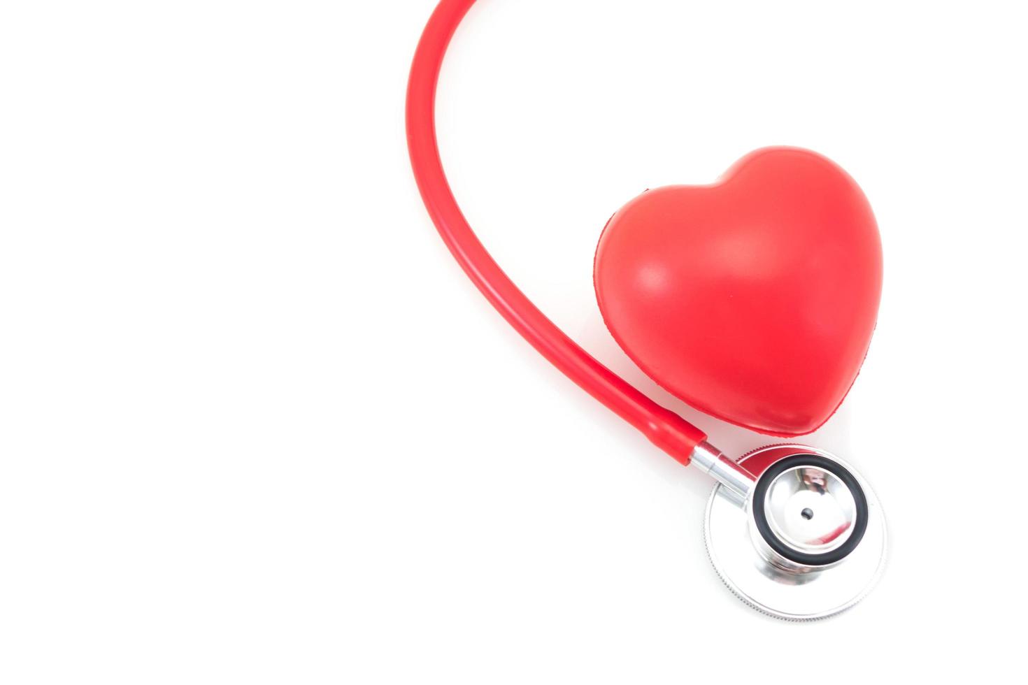 Stethoscope and red heart on white background photo