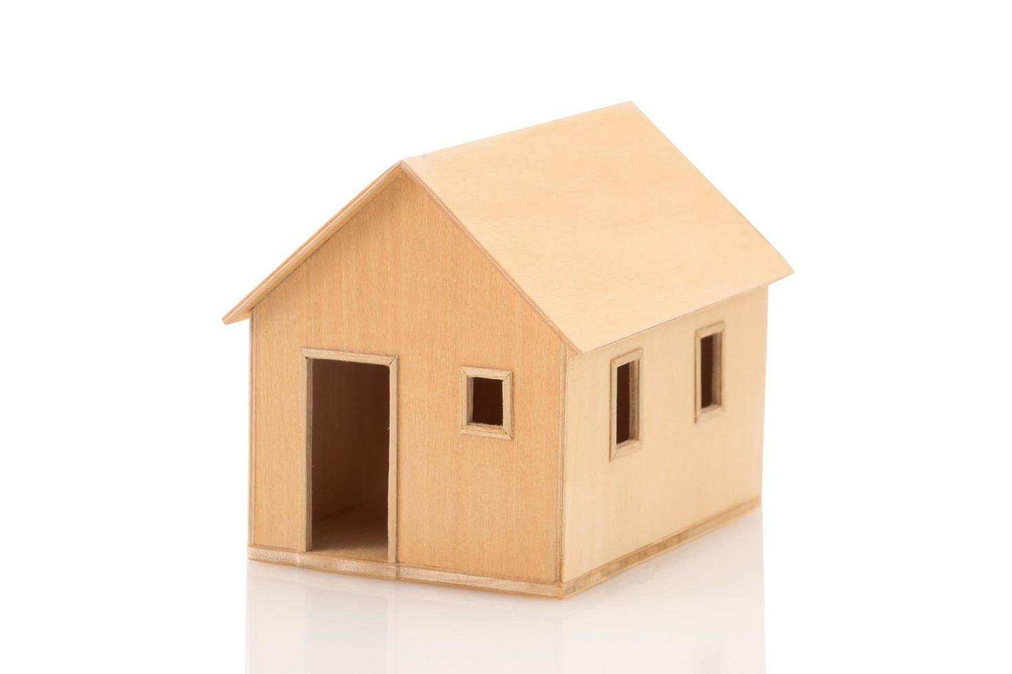 Toy wooden house model on white photo