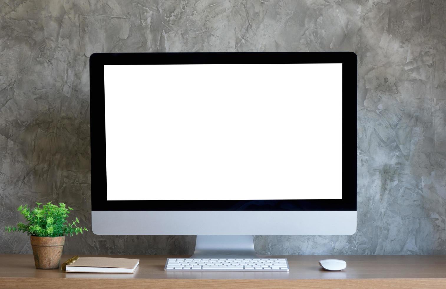 Desktop computer on work desk with blank screen photo