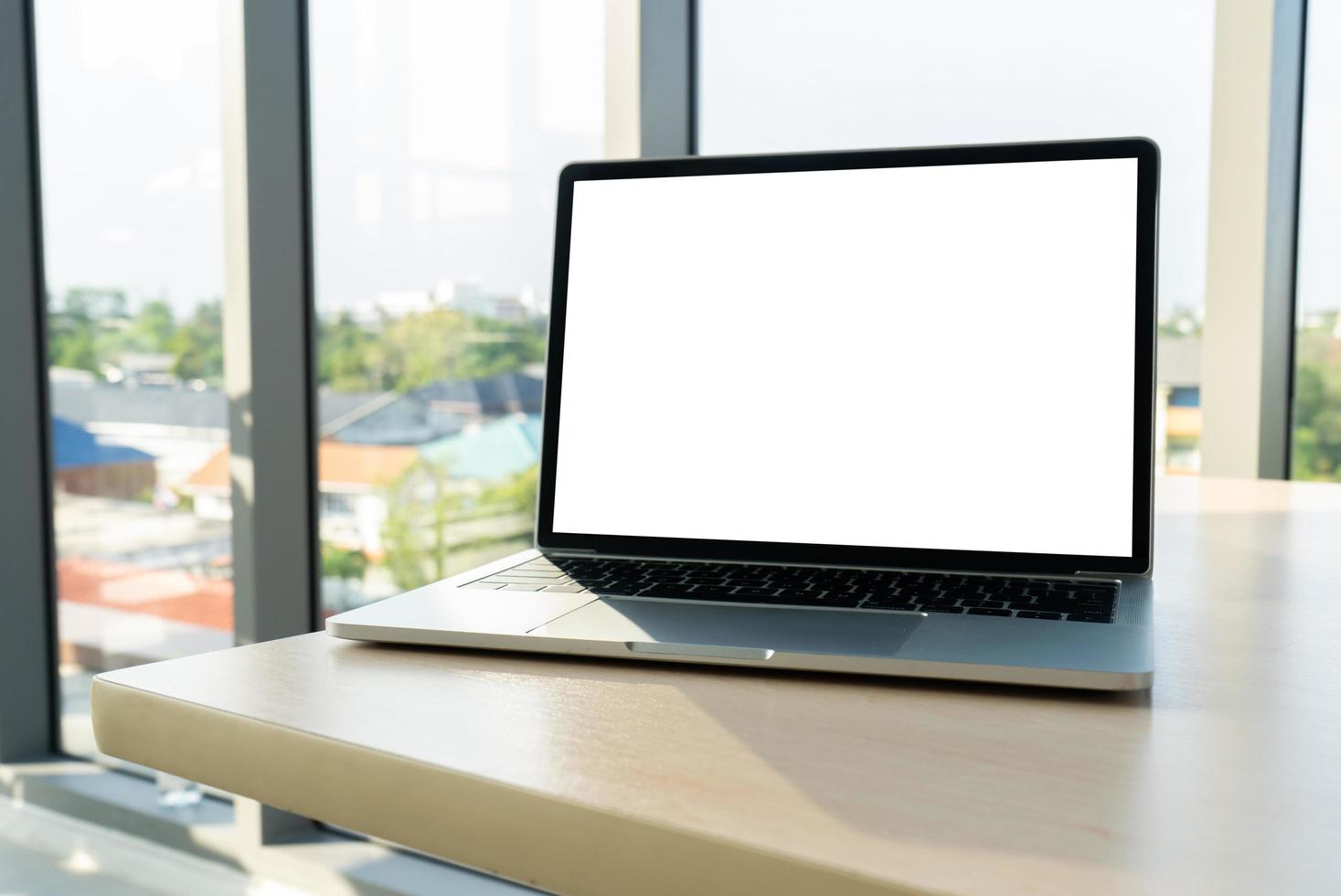 Notebook with blank screen on table in office photo