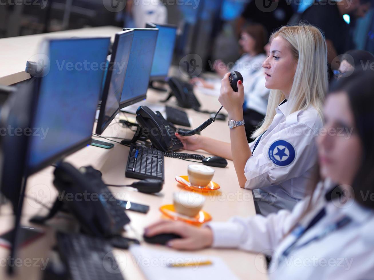 Female security guards working in a security data system control room photo