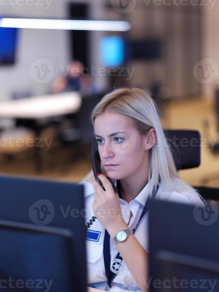 Female security guard operator talking on the phone photo